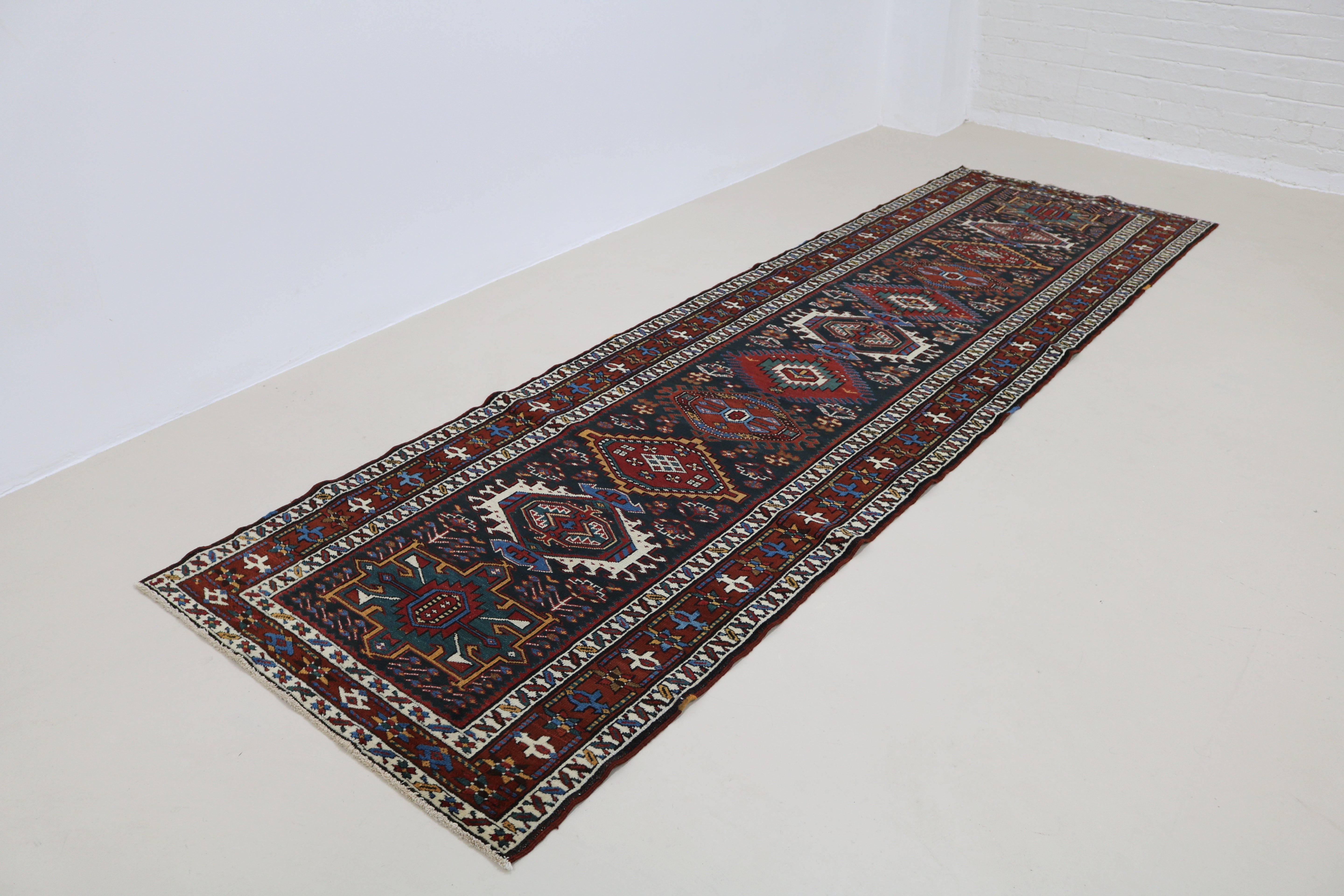 Angled view of antique Heriz runner highlighting overall pattern and proportions
