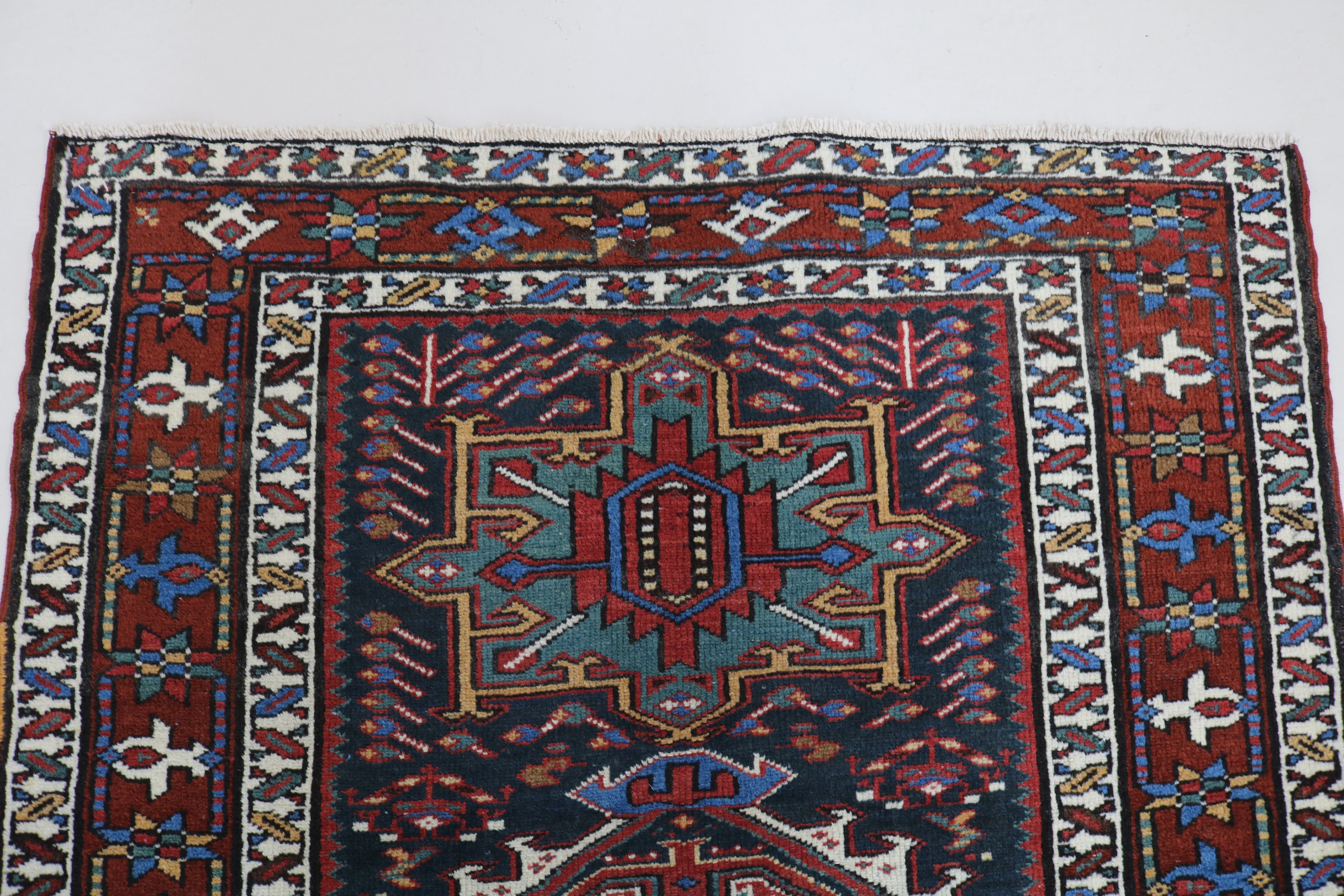 Close-up of hand-knotted wool texture on antique Heriz runner
