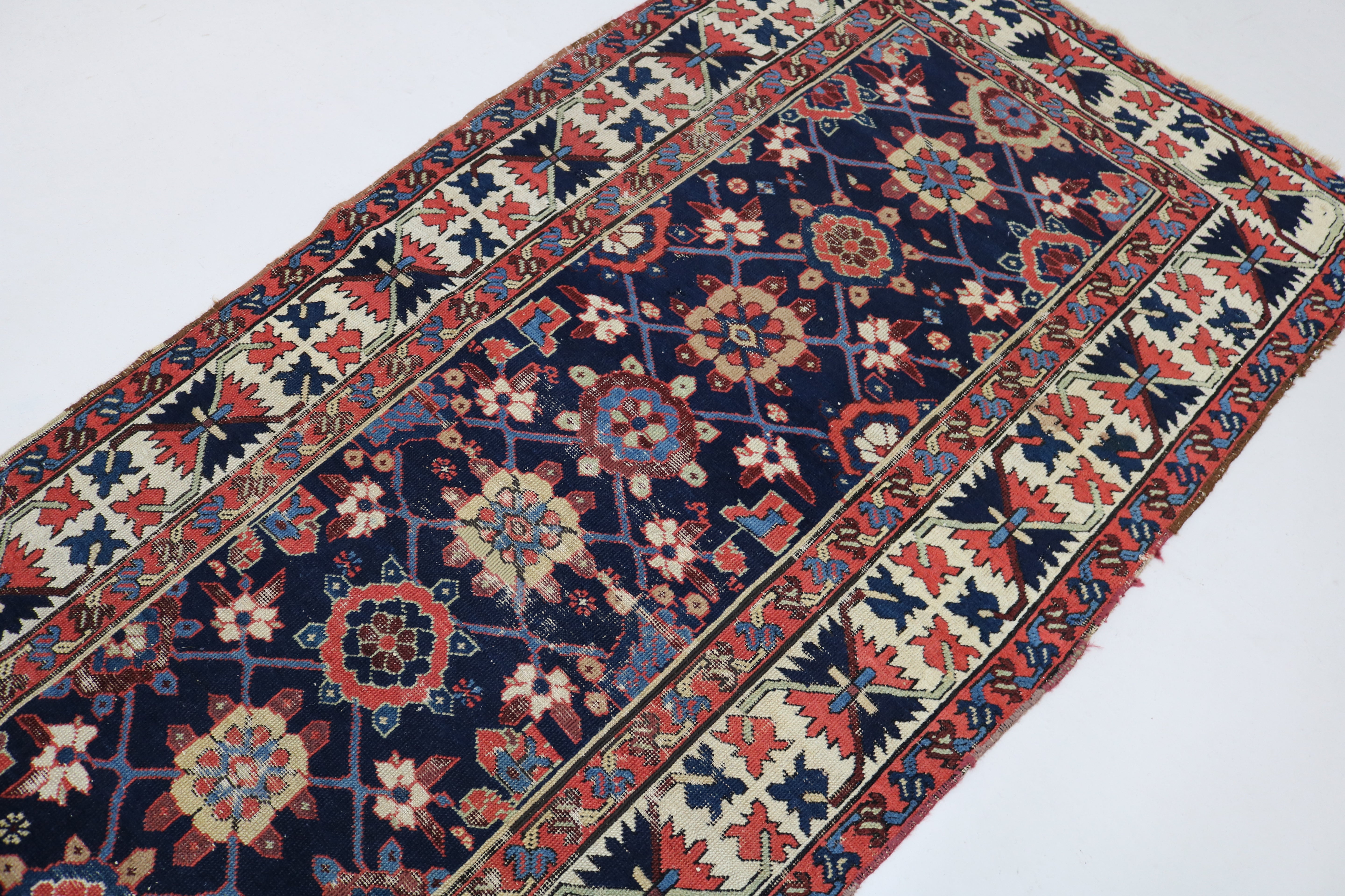 Close-up of hand-knotted wool texture on antique Caucasian Karabag runner
