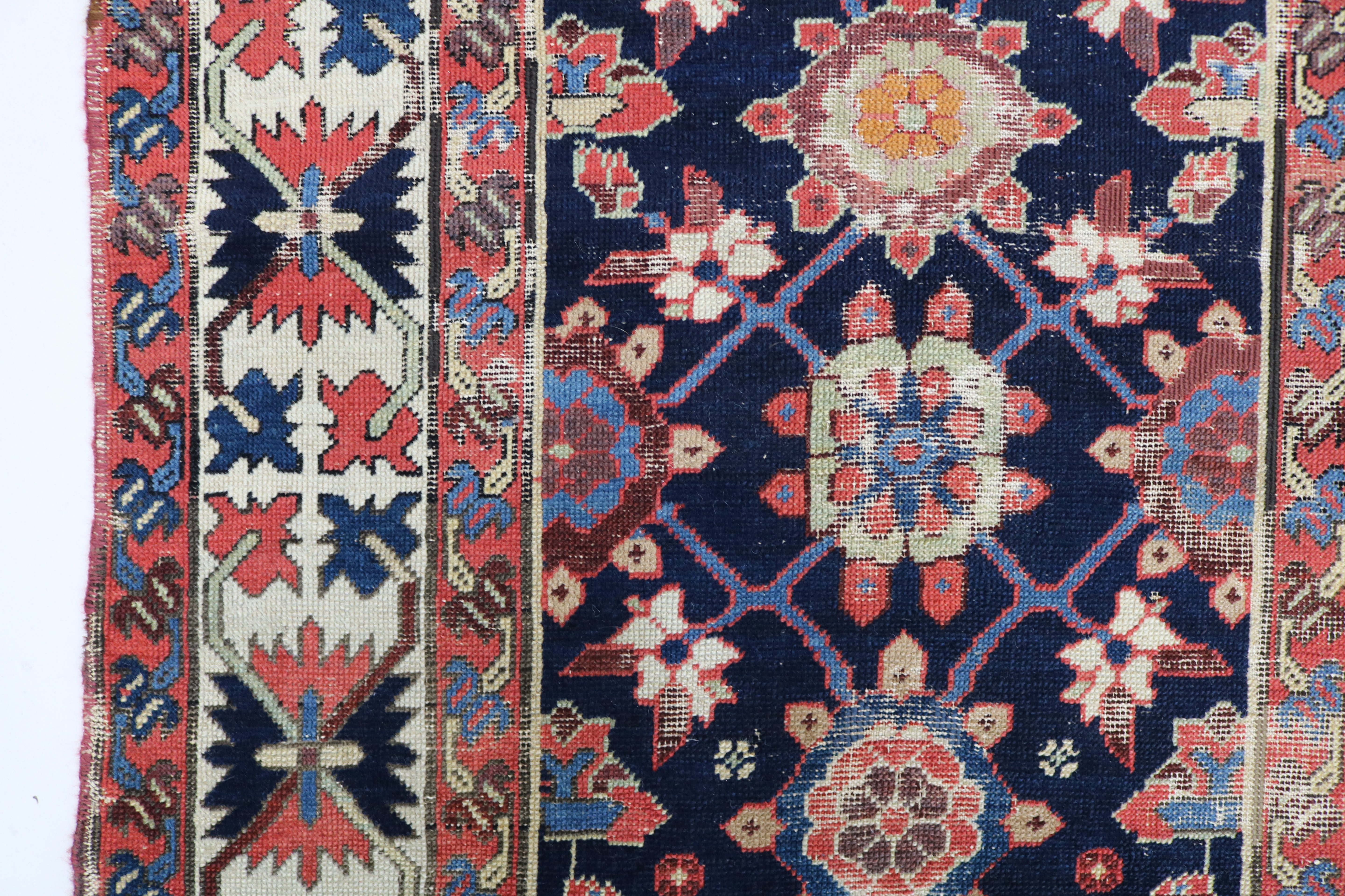 Close-up of hand-knotted wool texture on antique Caucasian Karabag runner
