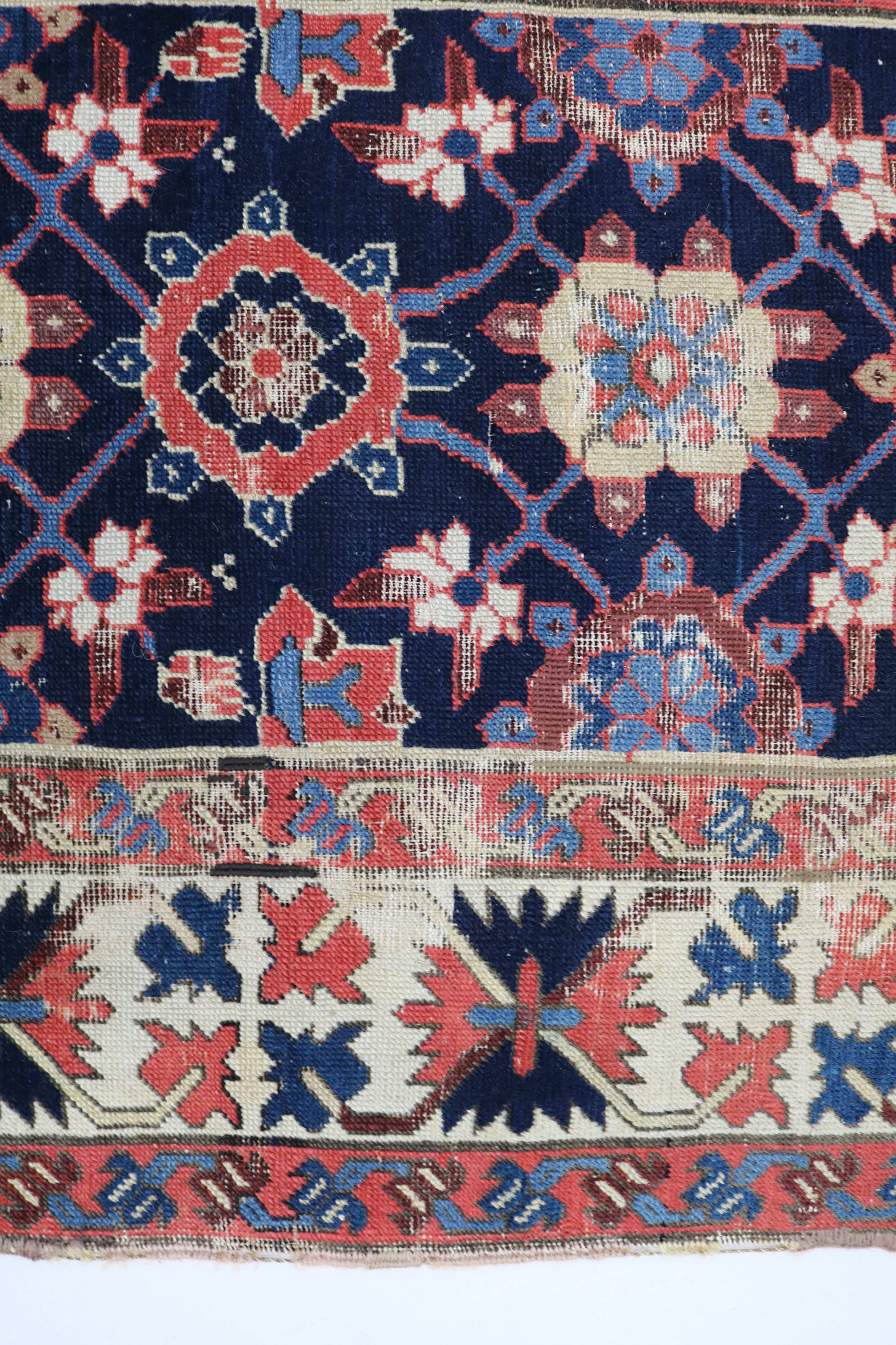 Close-up of hand-knotted wool texture on antique Caucasian Karabag runner

