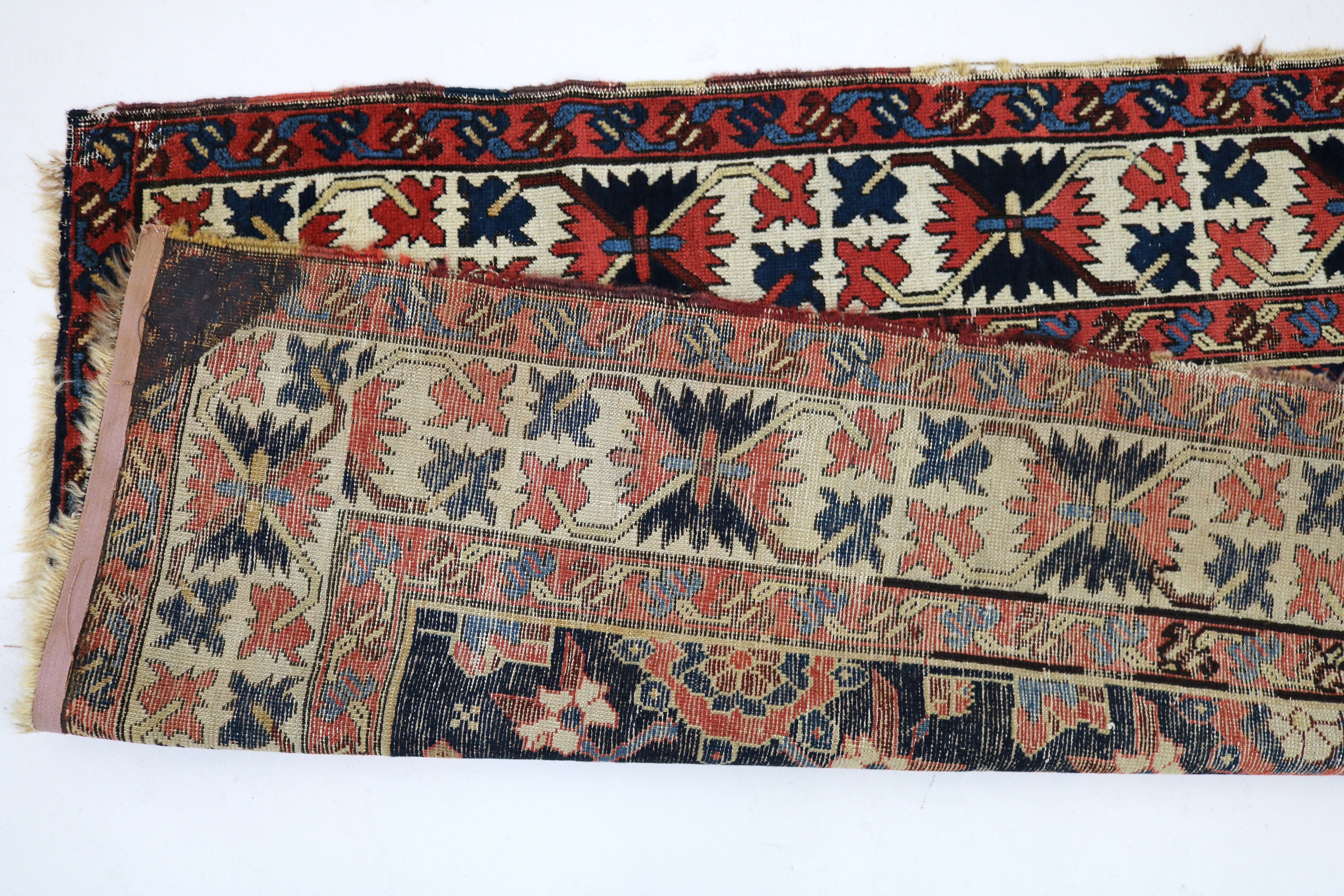 Close-up of hand-knotted wool texture on antique Caucasian Karabag runner
