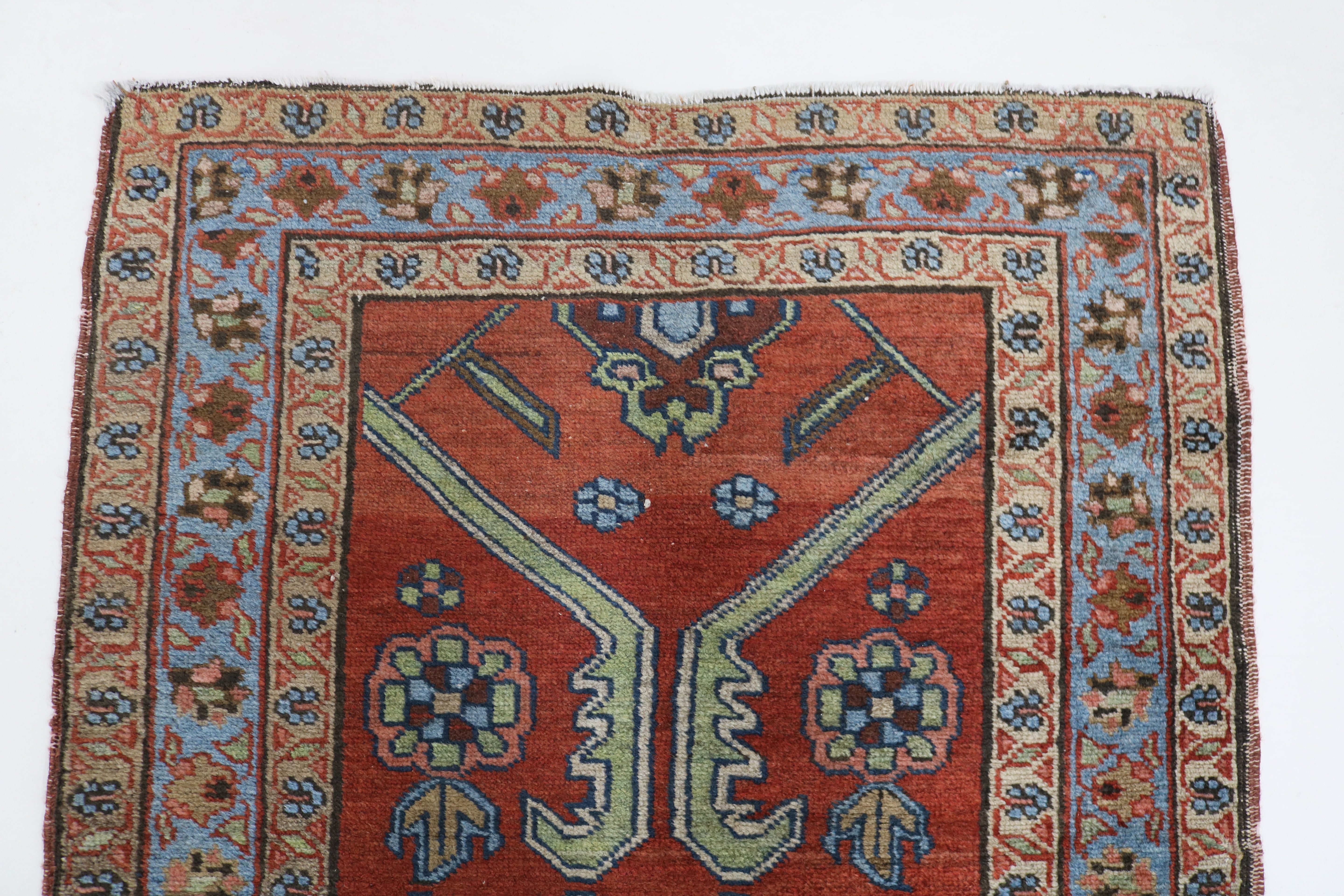 Close-up of hand-knotted wool texture on antique Persian Heriz rug
