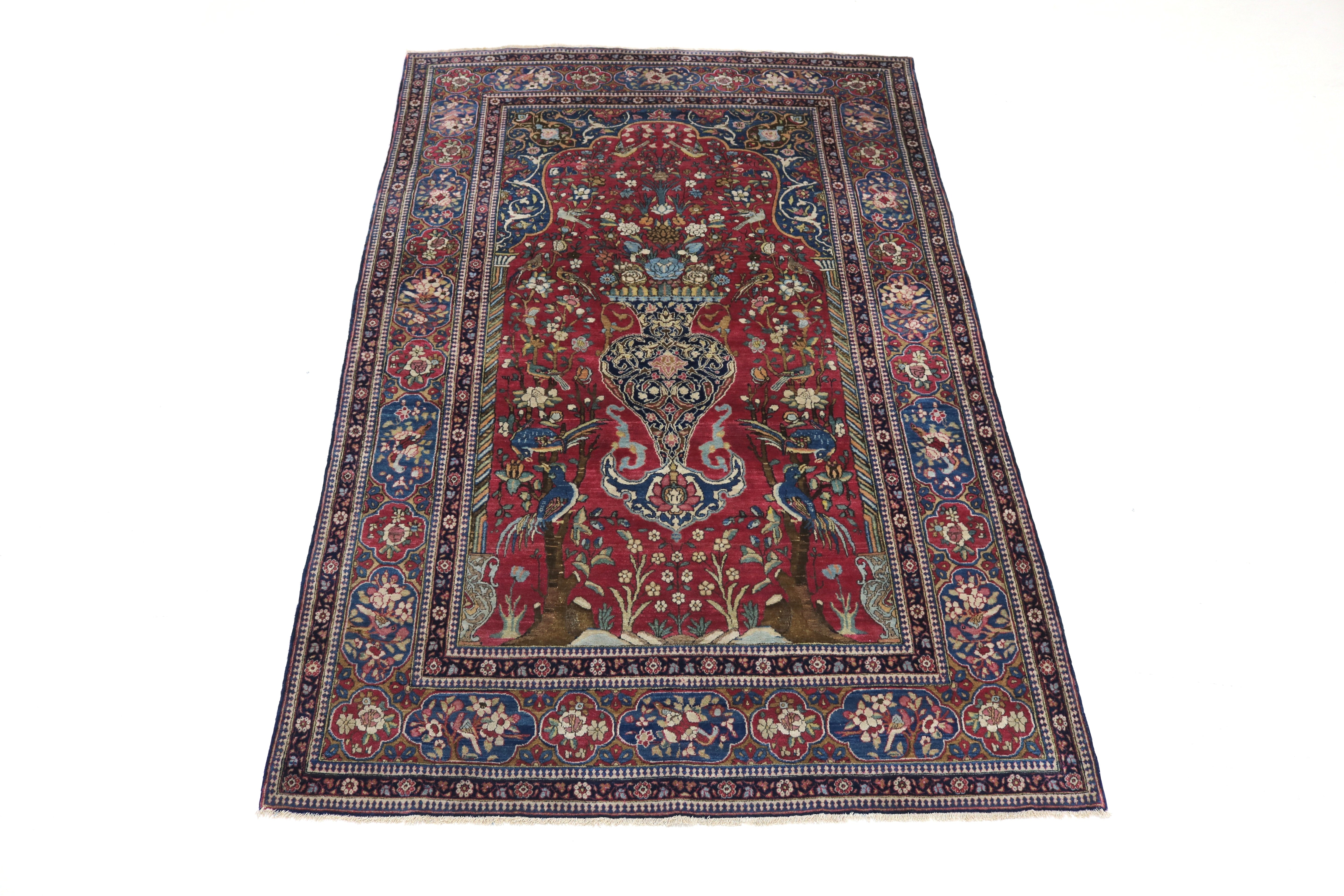 Full view of antique Isfahan rug with finely drawn floral field and balanced borders
