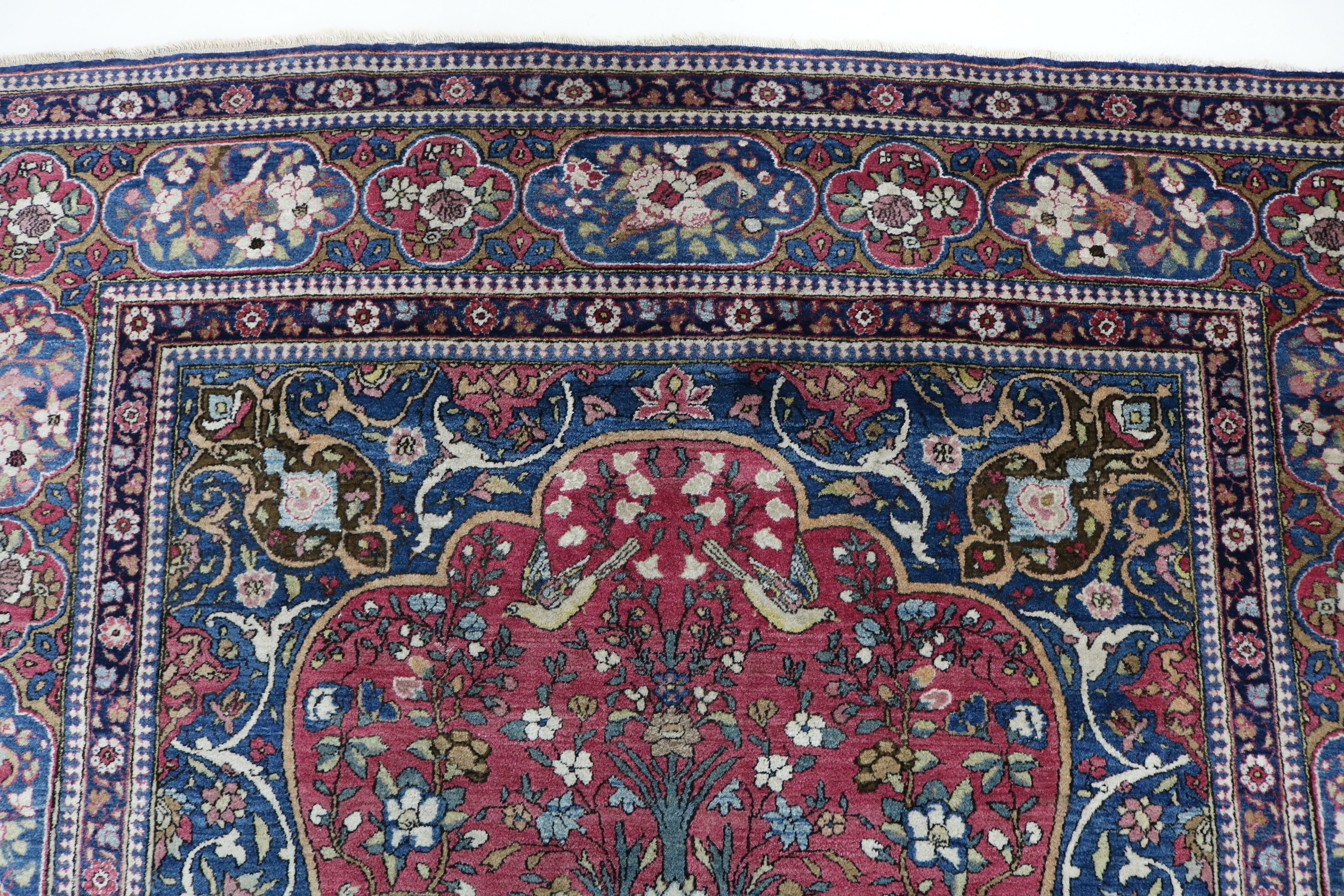 Close-up of finely knotted wool texture on antique Isfahan rug
