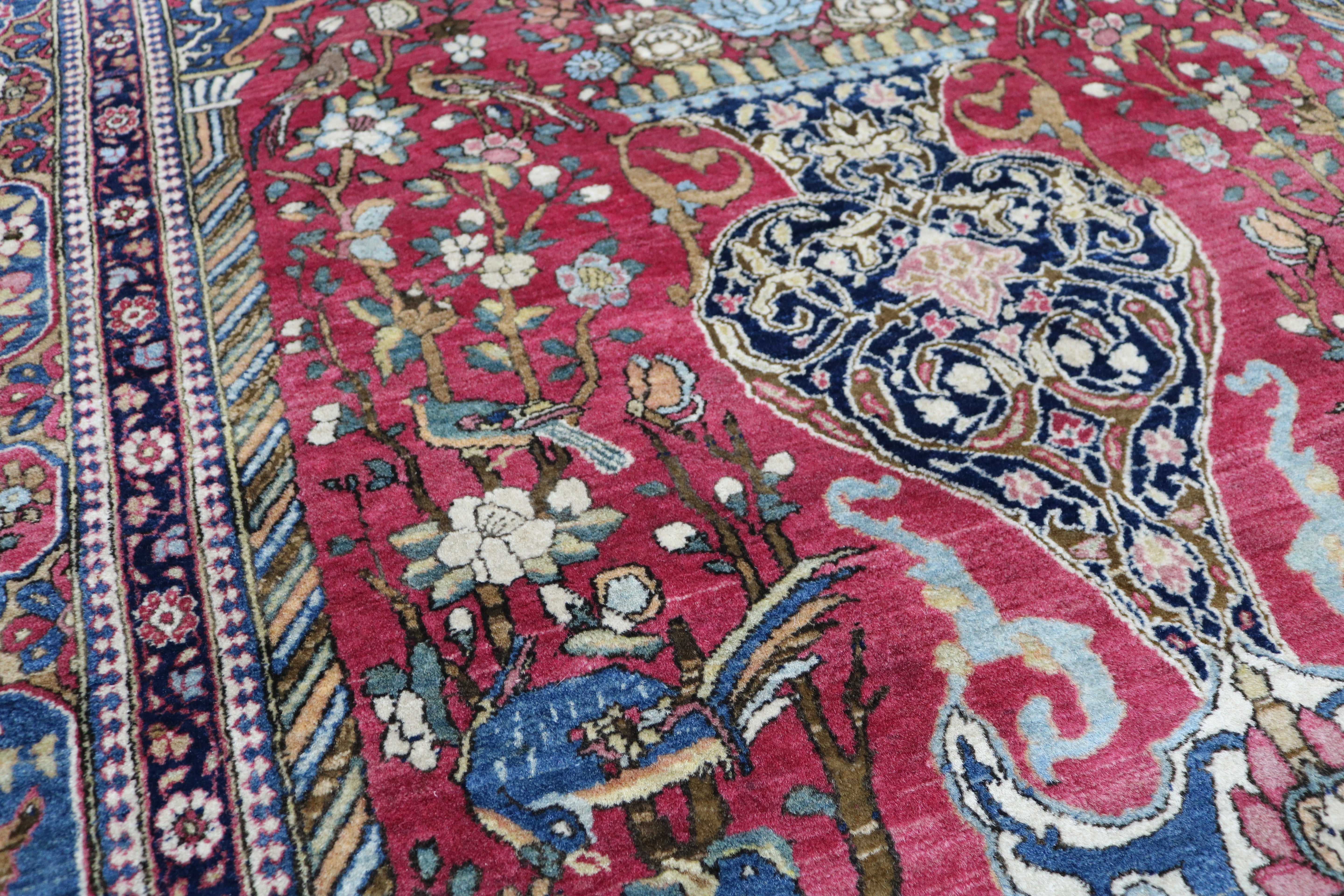 Close-up of finely knotted wool texture on antique Isfahan rug
