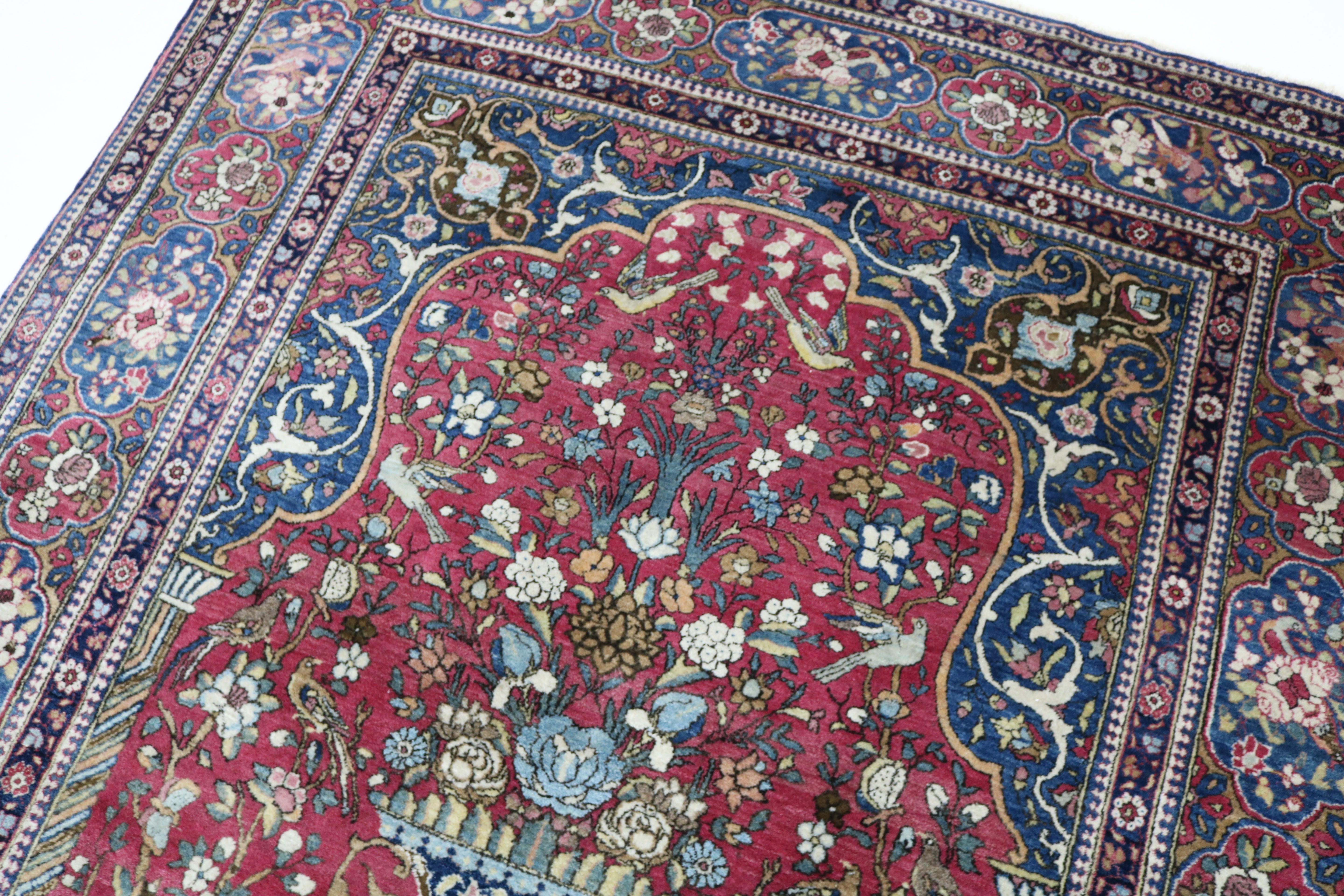 Close-up of finely knotted wool texture on antique Isfahan rug

