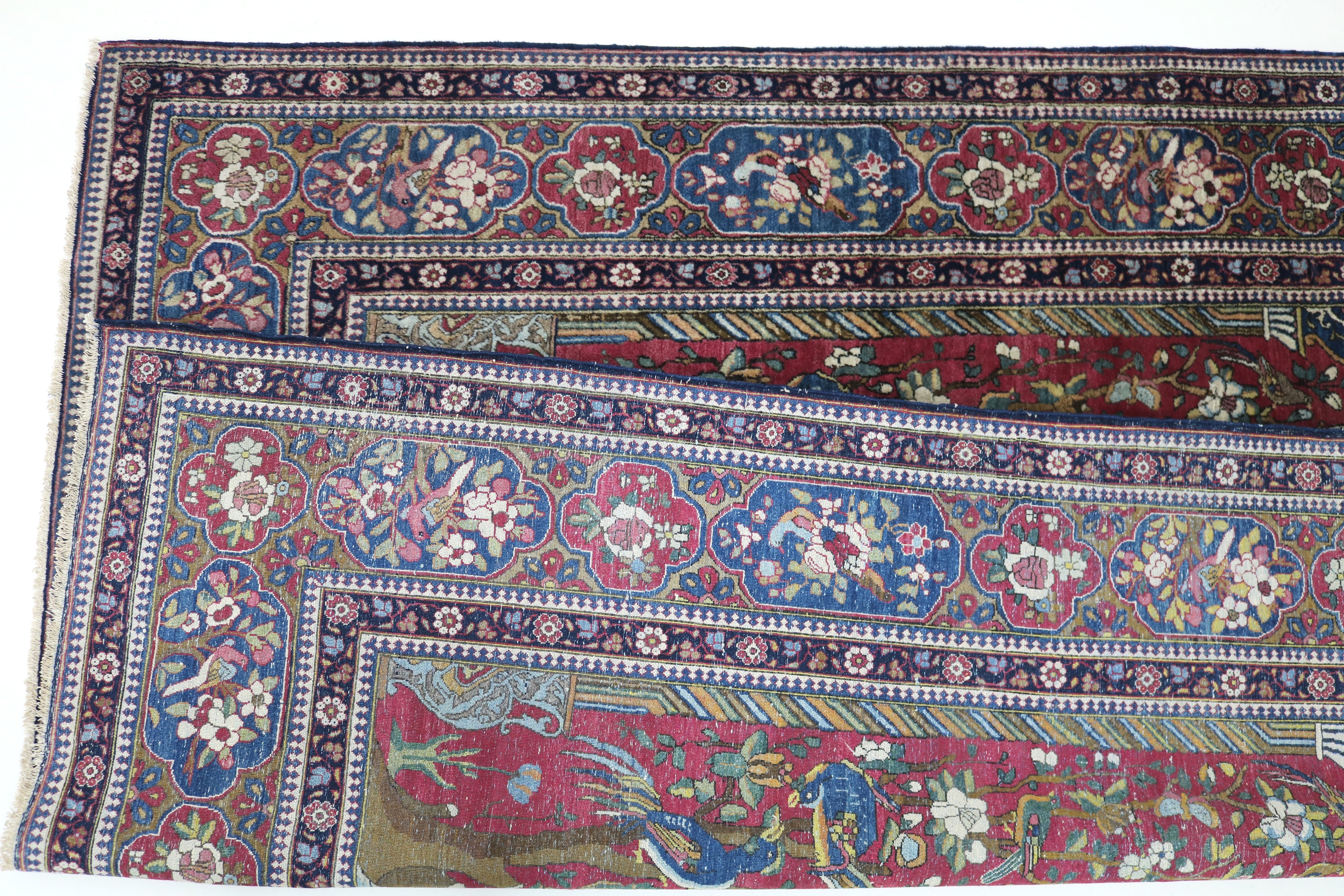Close-up of finely knotted wool texture on antique Isfahan rug
