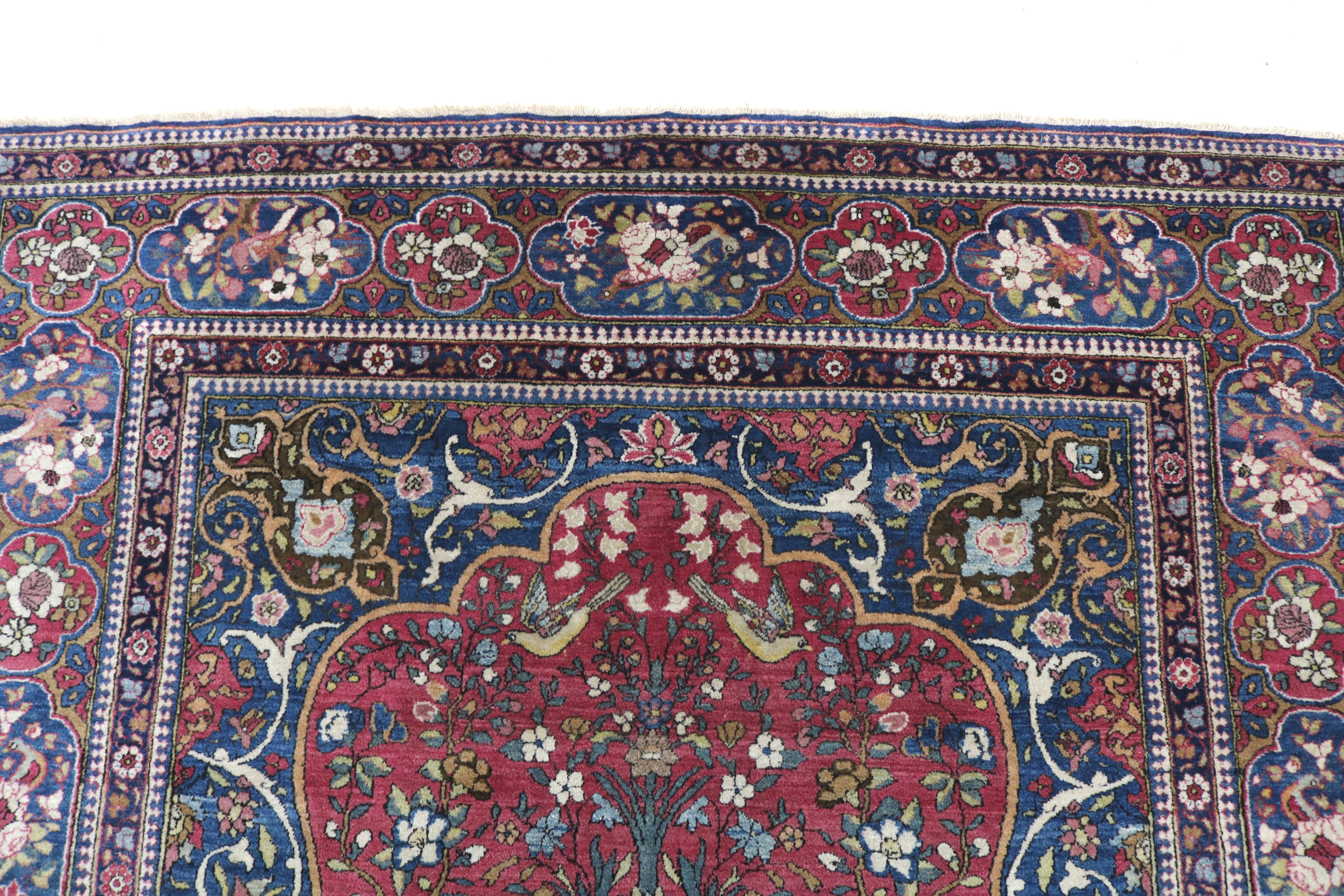 Close-up of finely knotted wool texture on antique Isfahan rug
