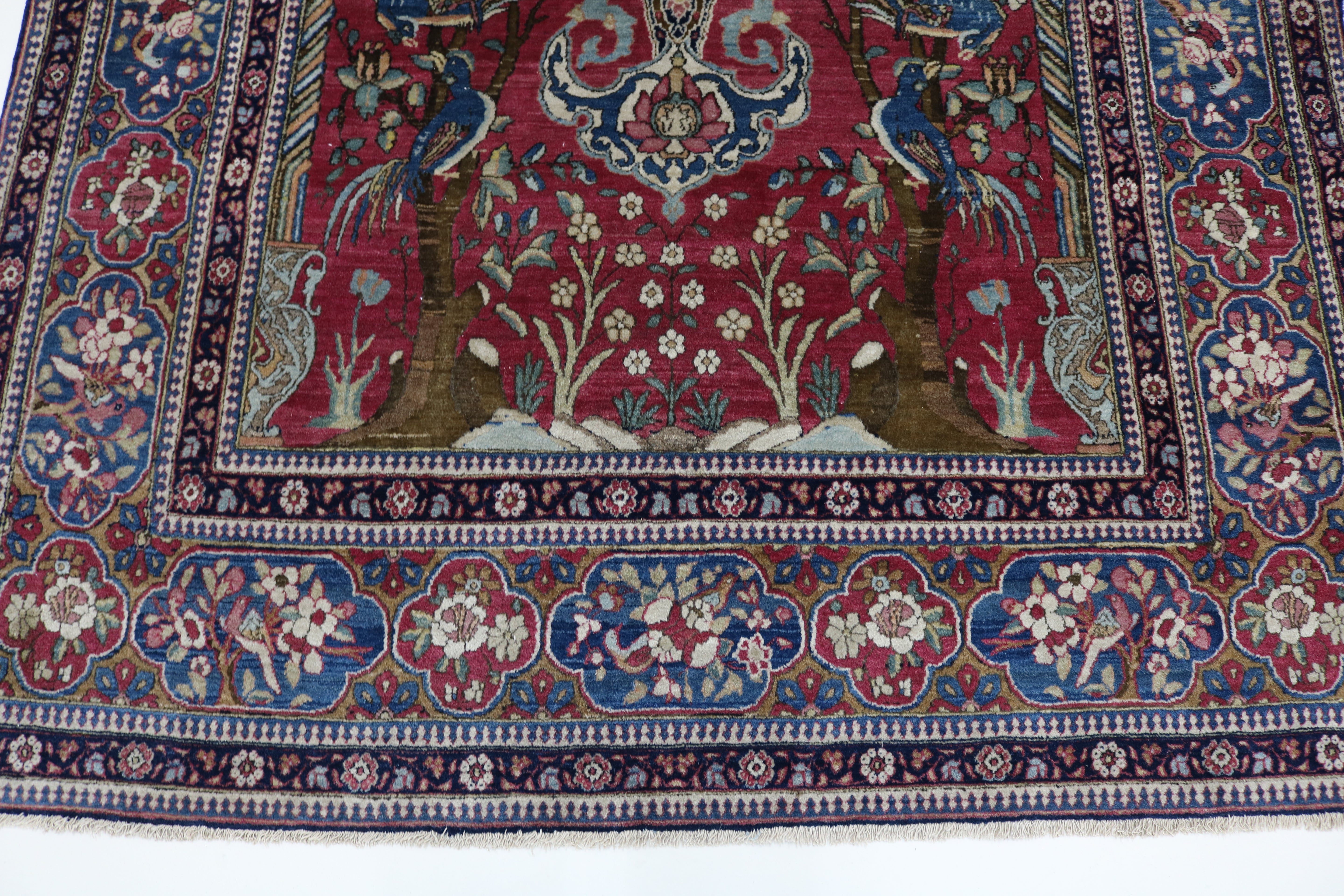 Close-up of finely knotted wool texture on antique Isfahan rug
