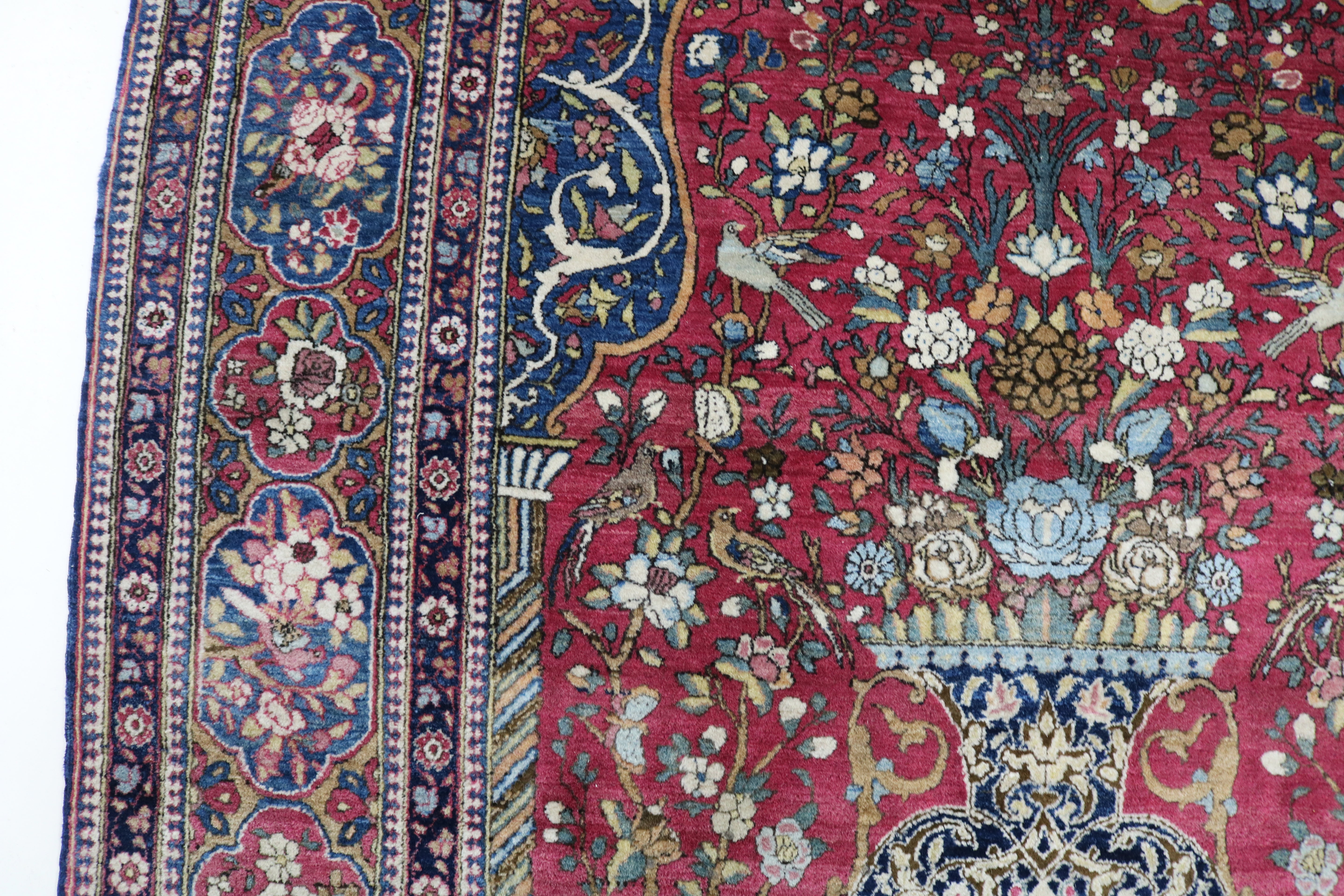 Close-up of finely knotted wool texture on antique Isfahan rug
