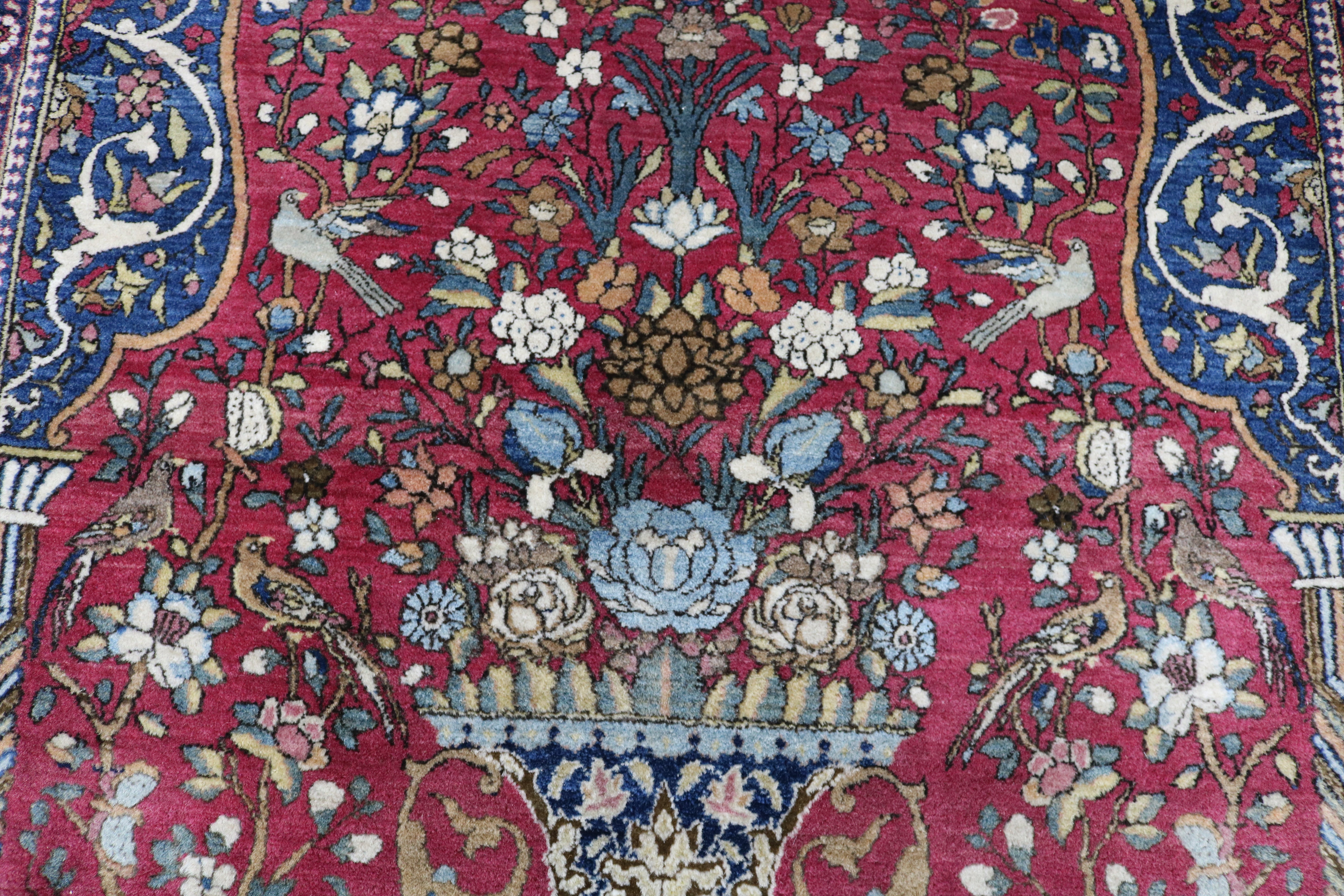 Close-up of finely knotted wool texture on antique Isfahan rug

