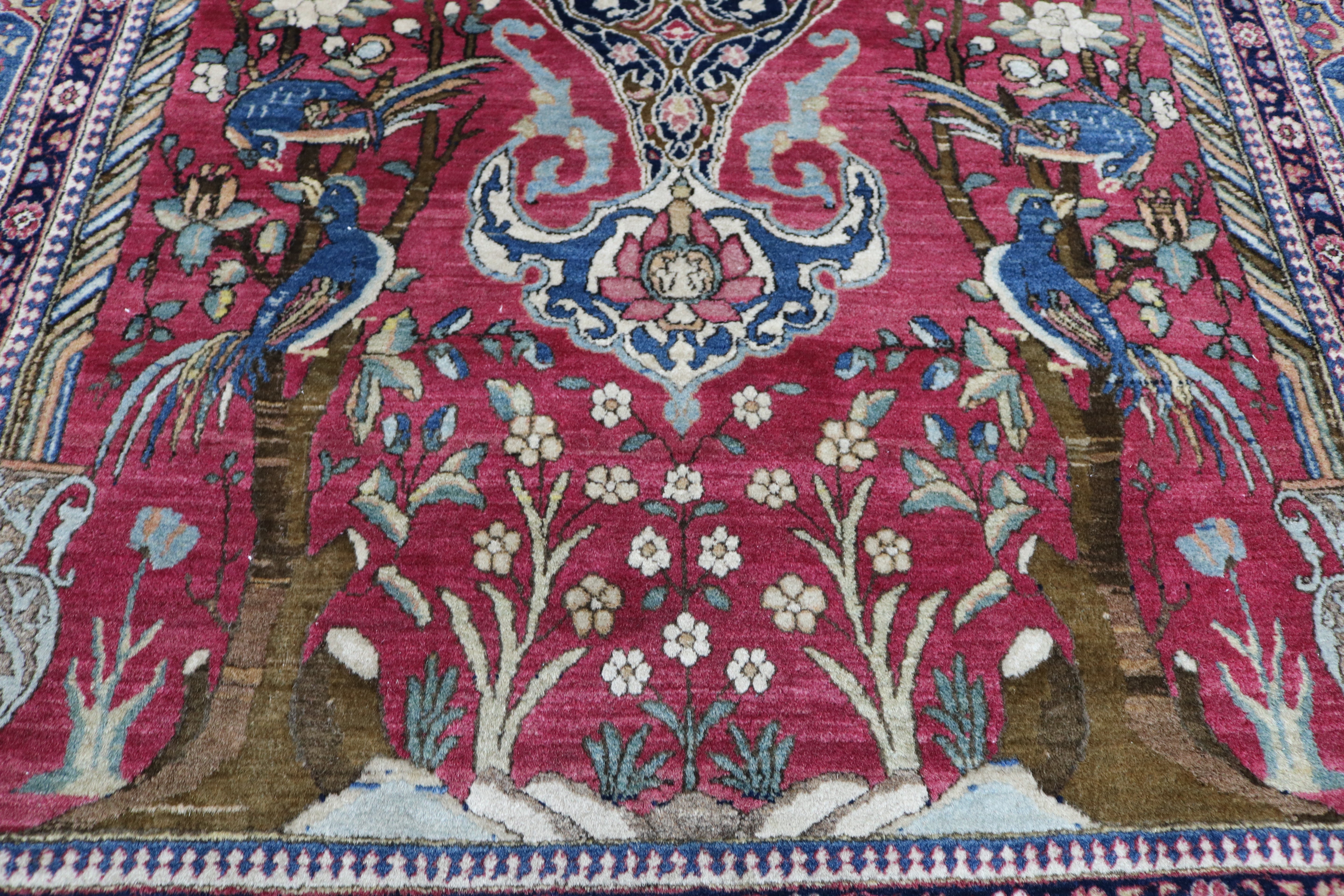 Close-up of finely knotted wool texture on antique Isfahan rug
