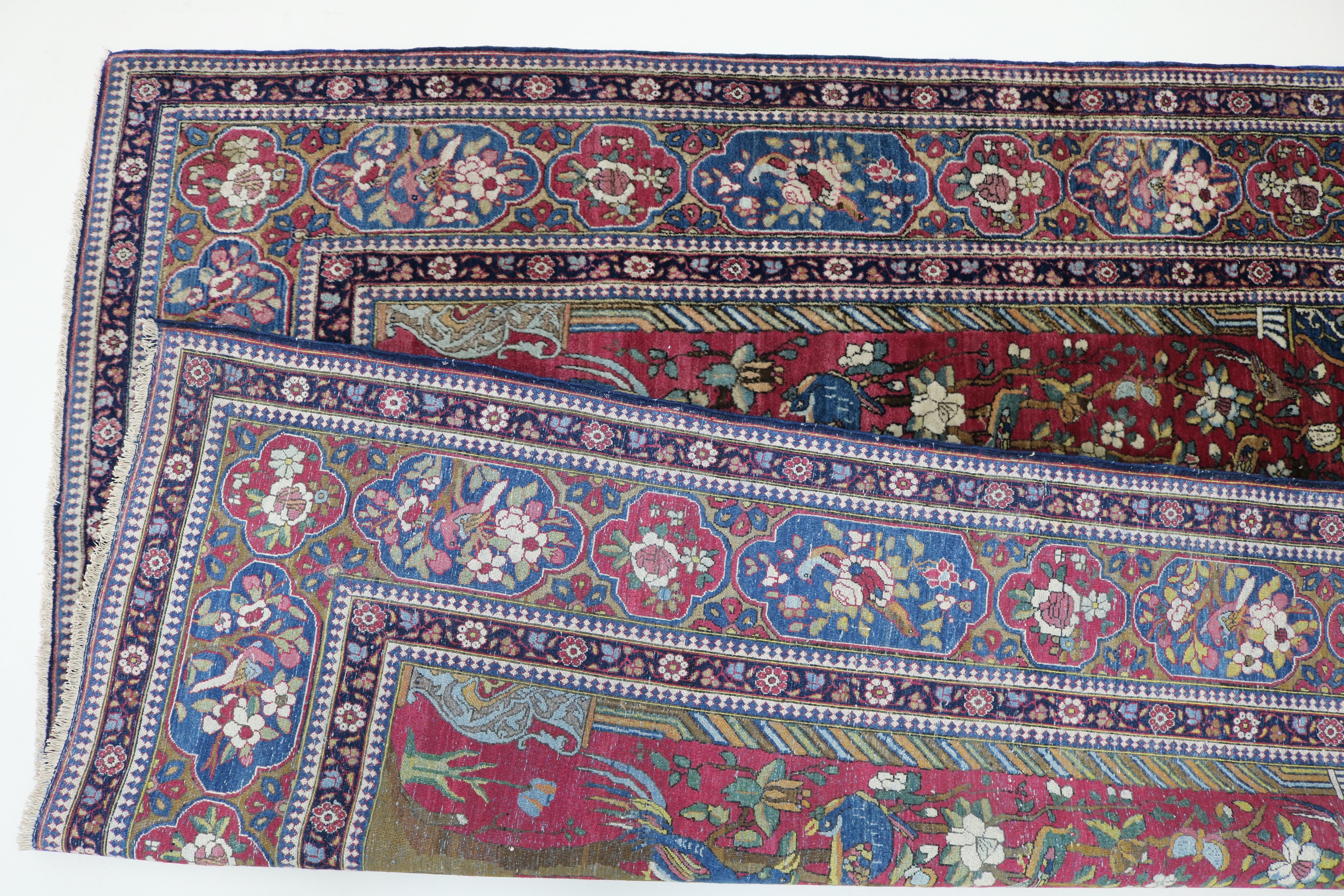 Close-up of finely knotted wool texture on antique Isfahan rug
