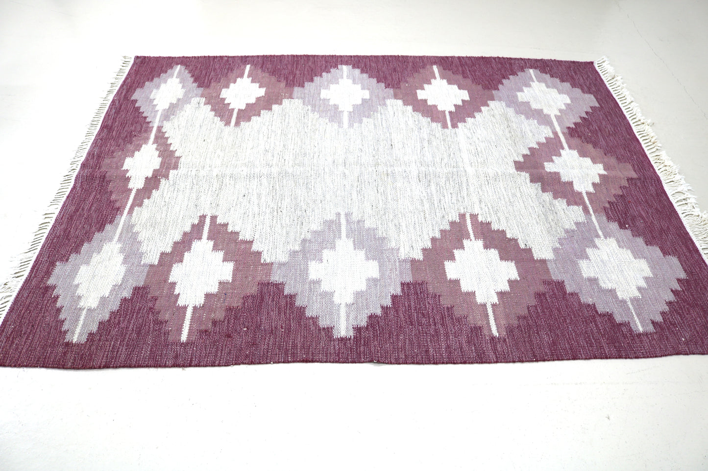 Detail of vintage Swedish Kilim rug showing handwoven wool texture and Scandinavian geometric pattern, mid-century flatweave