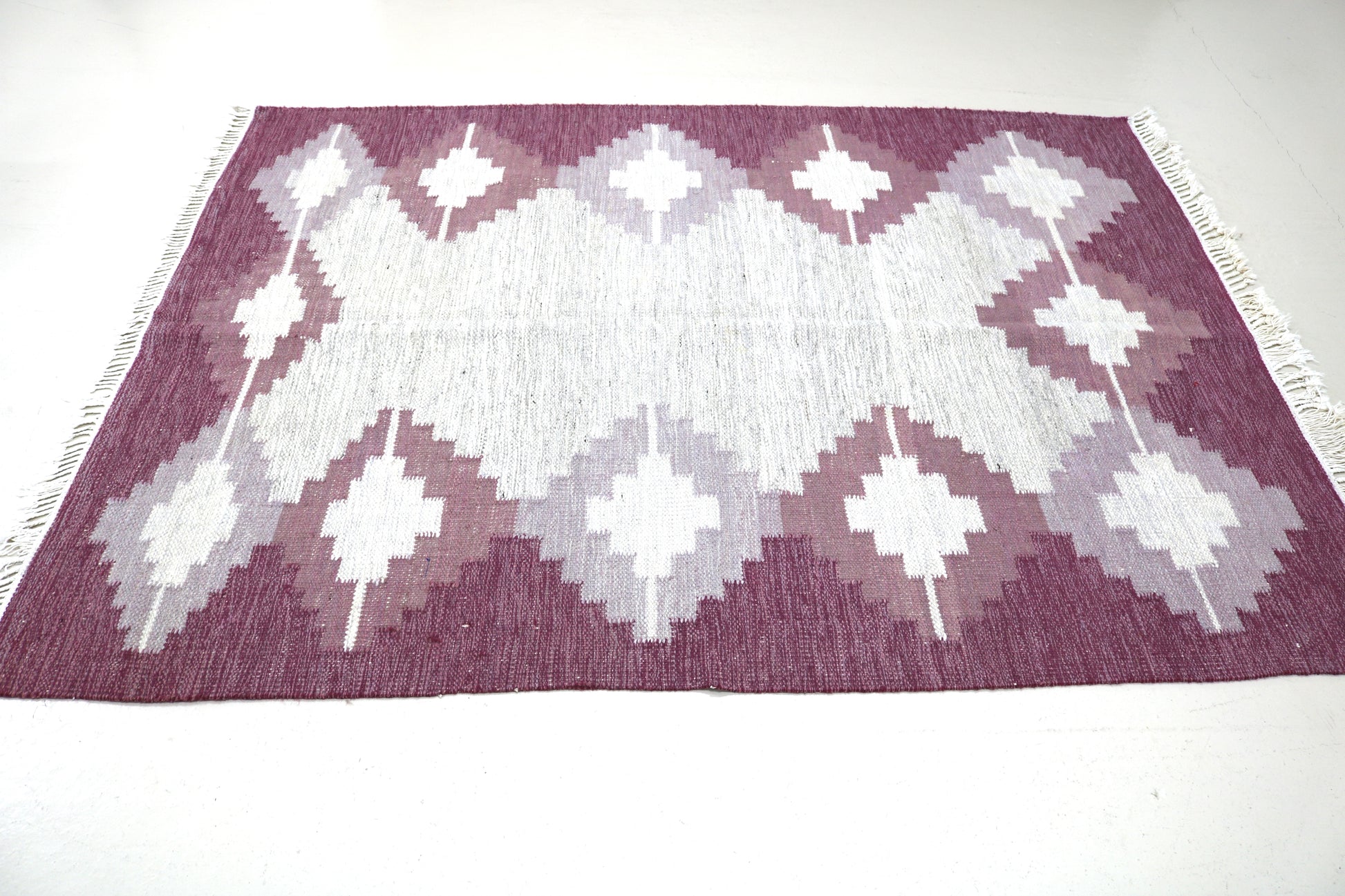 Detail of vintage Swedish Kilim rug showing handwoven wool texture and Scandinavian geometric pattern, mid-century flatweave