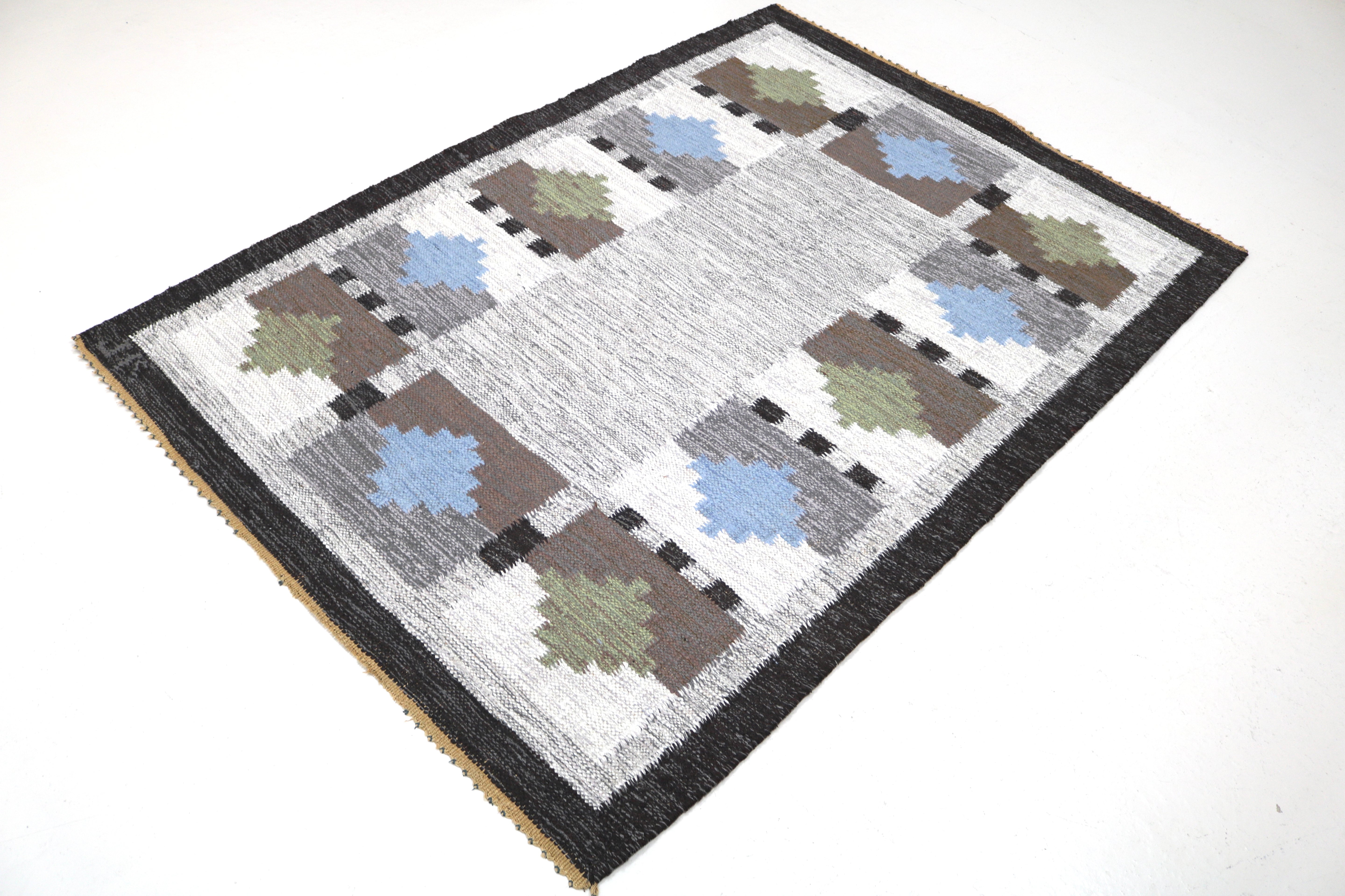 Vintage Swedish wool rug showing full geometric design in muted Scandinavian colours
