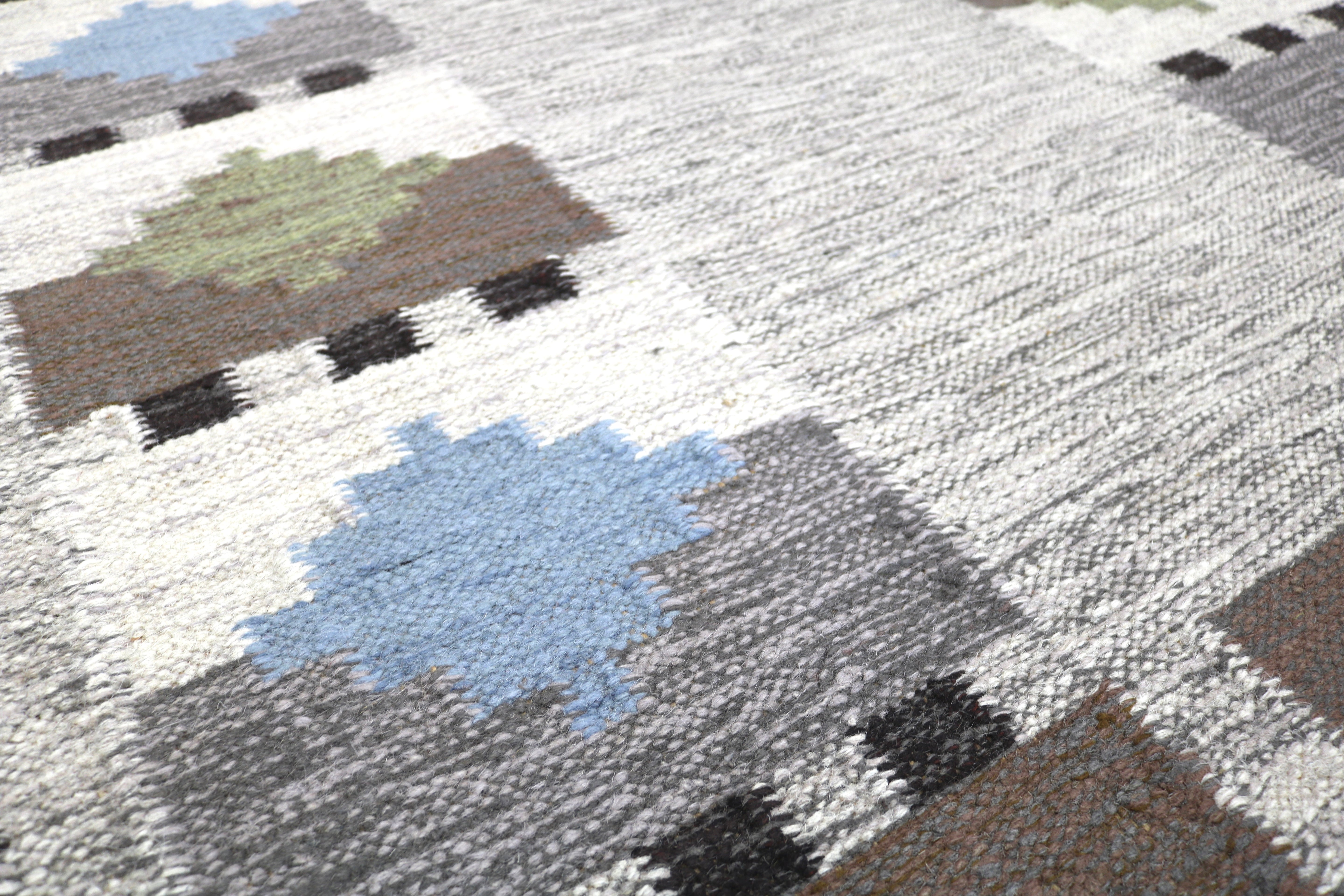 Corner detail of vintage Swedish rug with handwoven geometric motifs