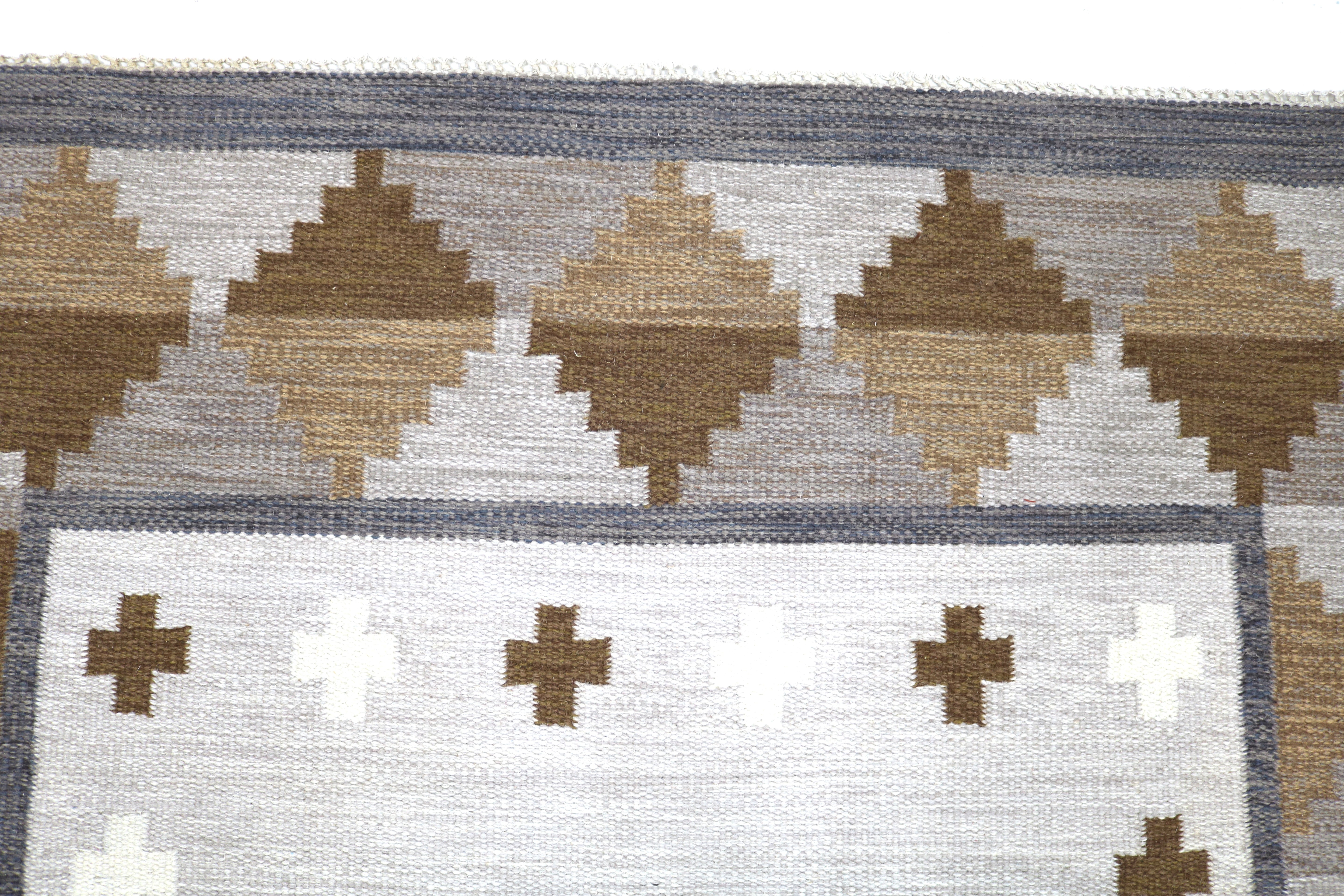 Close-up of geometric motifs on an authentic Swedish wool flatweave rug.