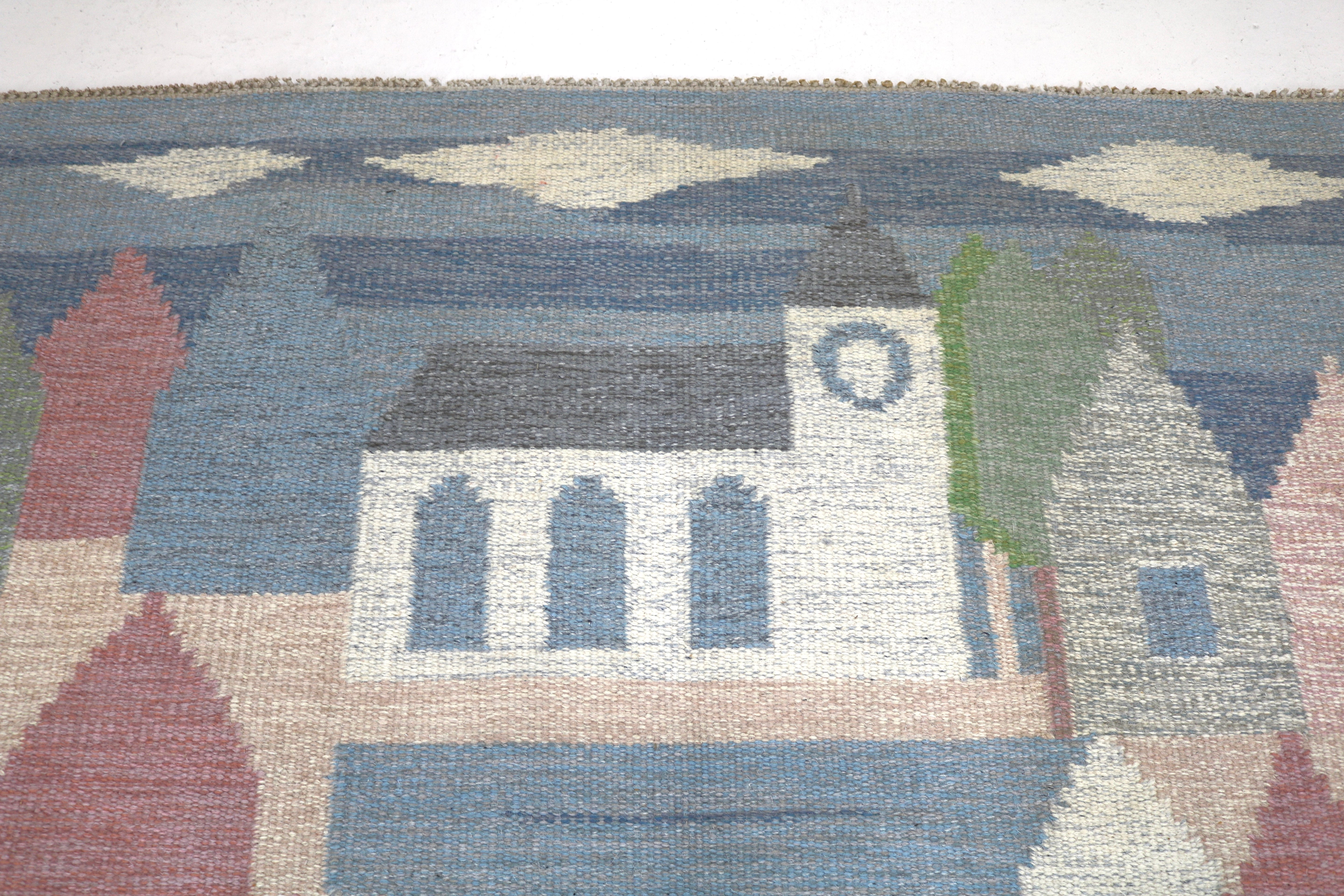 Detail of traditional Scandinavian wool weaving featuring geometric buildings.