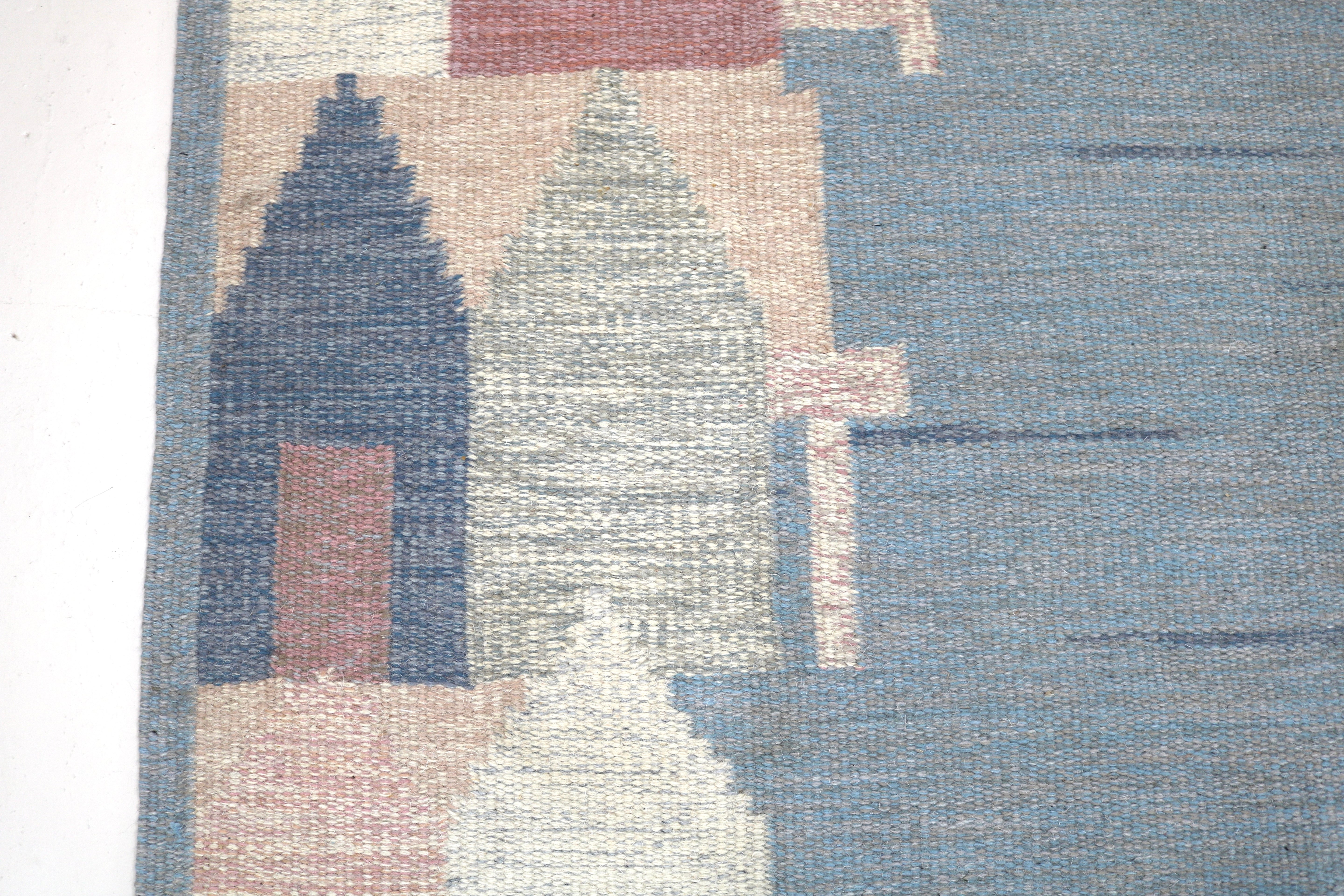 Close-up showing the texture and craftsmanship of an authentic Swedish wool flatweave rug.
