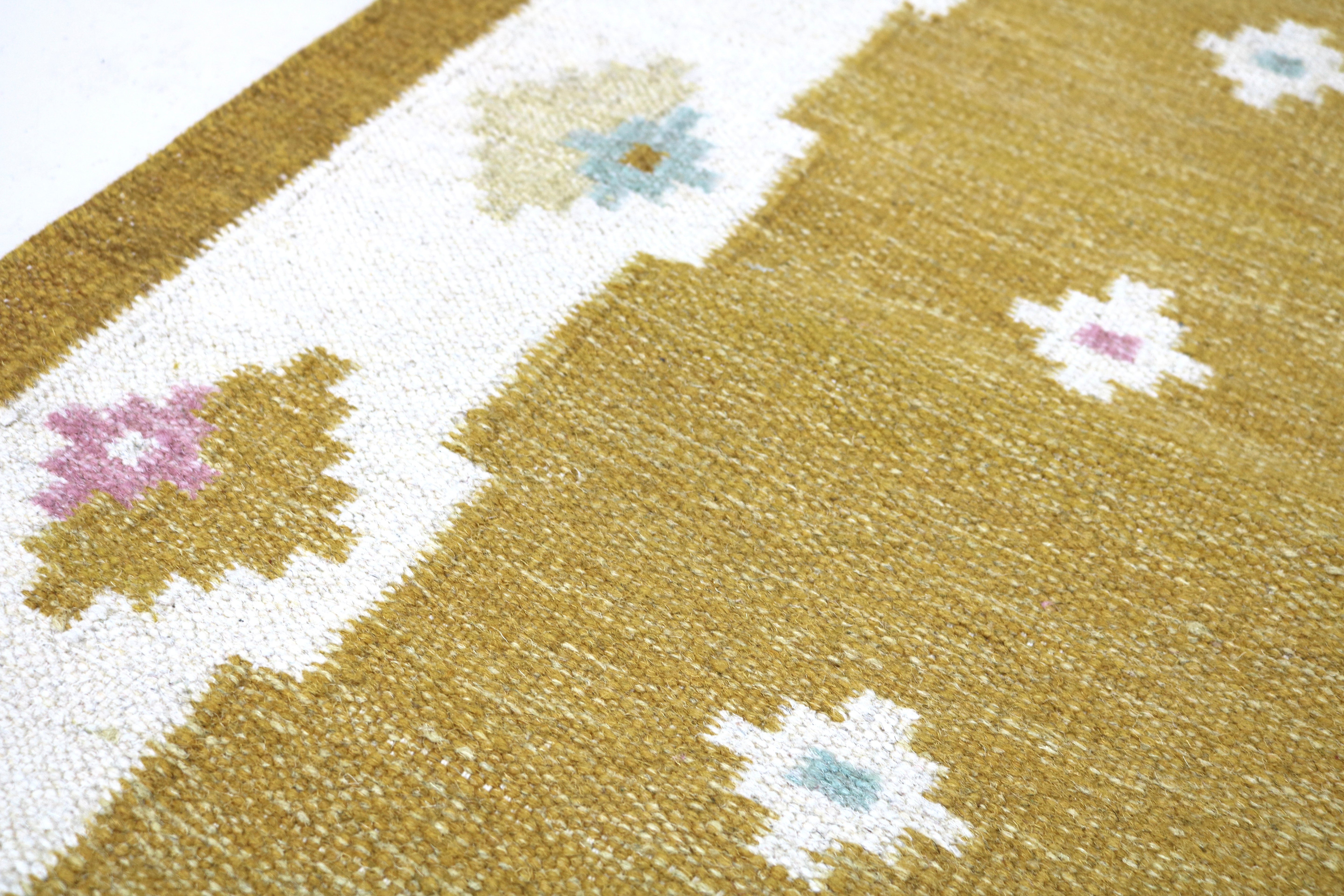 Corner detail of a vintage Swedish runner with Scandinavian floral design.