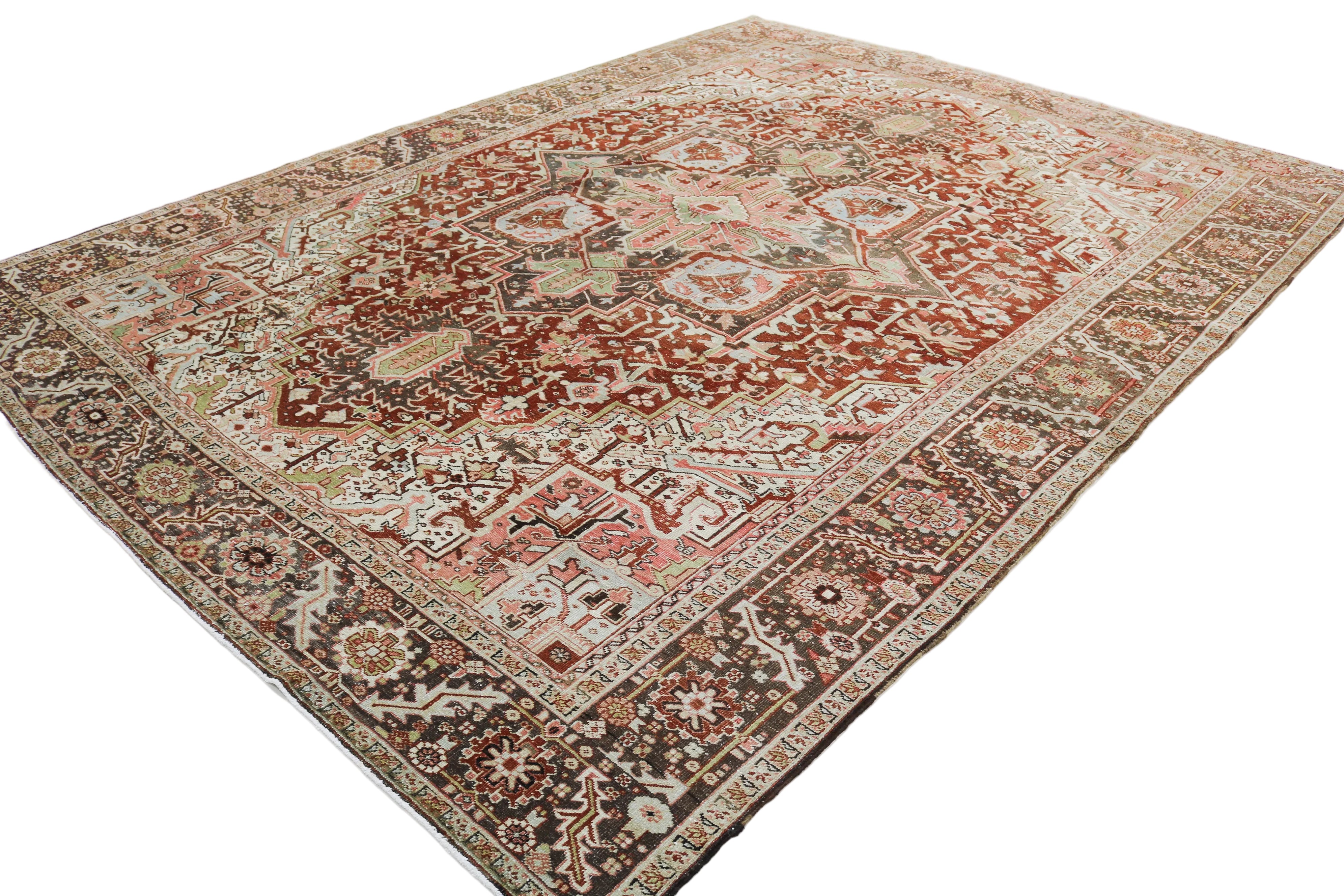 Hand-knotted antique Persian Heriz rug with bold geometric pattern and richly aged colours