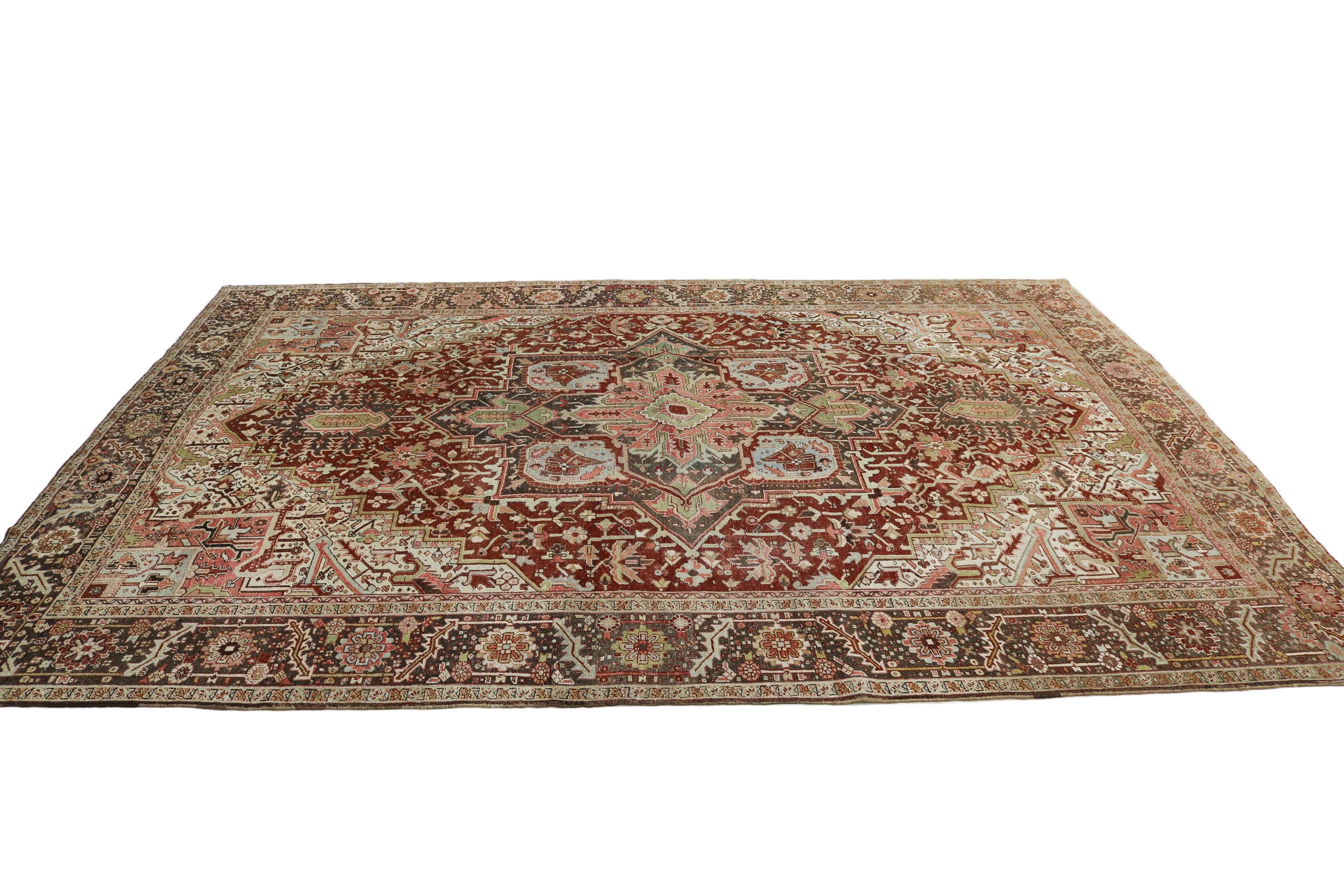 Close-up detail of antique Persian Heriz rug showing handwoven geometric motifs and natural wool colours