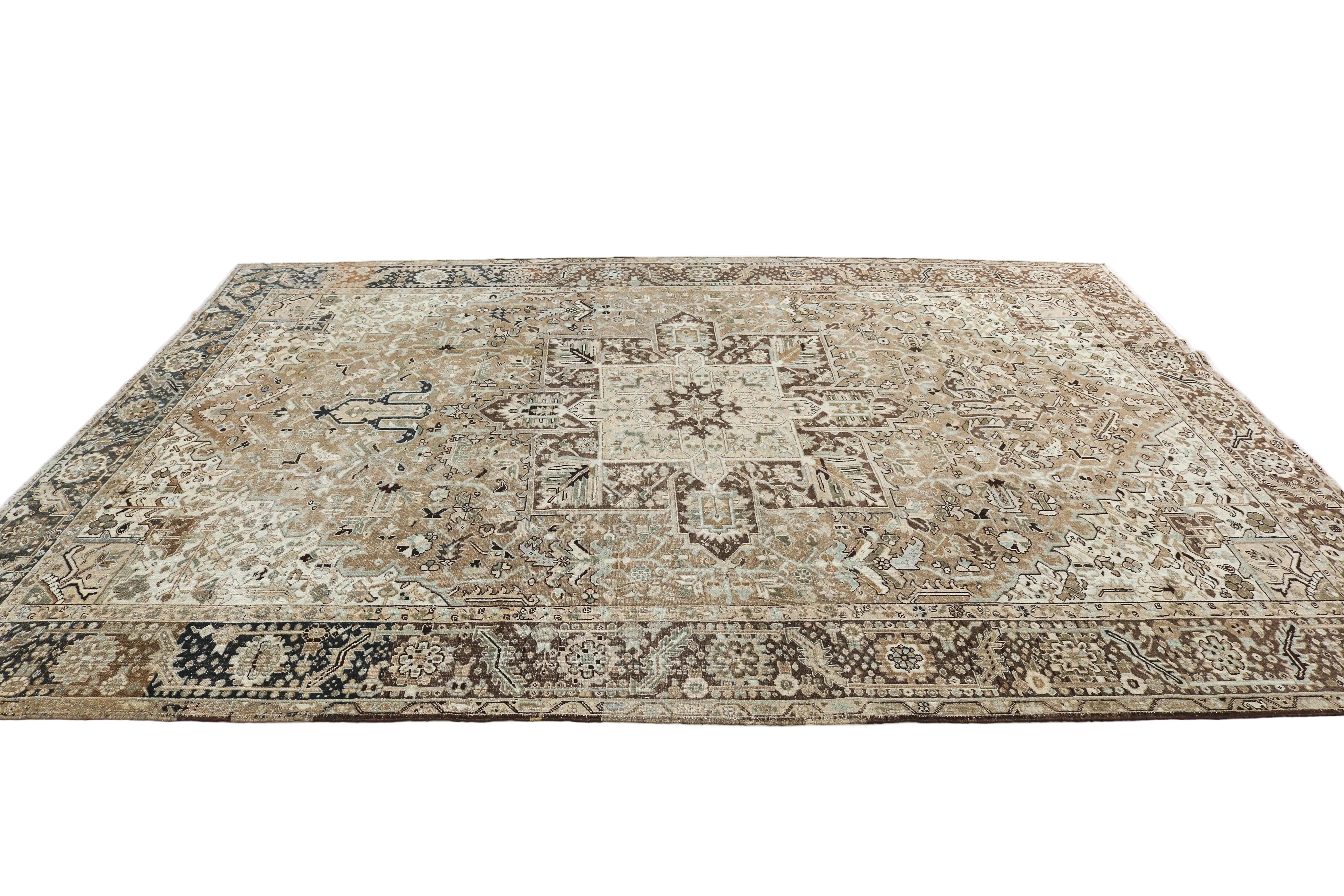 Oversized antique Persian Heriz carpet circa 1930 displayed with traditional geometric medallion design