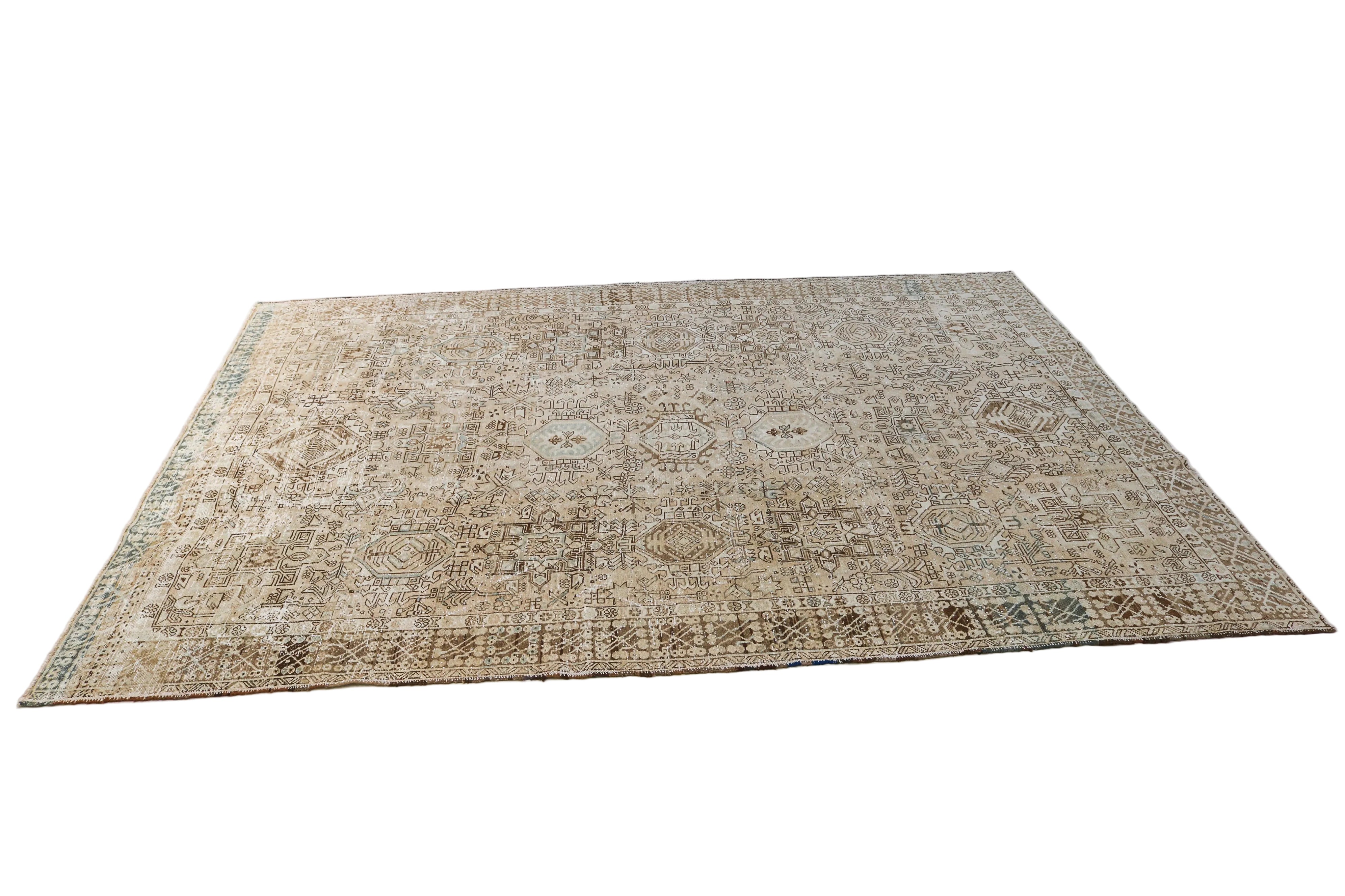 Hand-knotted antique Persian Heriz-Karaja rug with detailed tribal pattern and muted natural colours