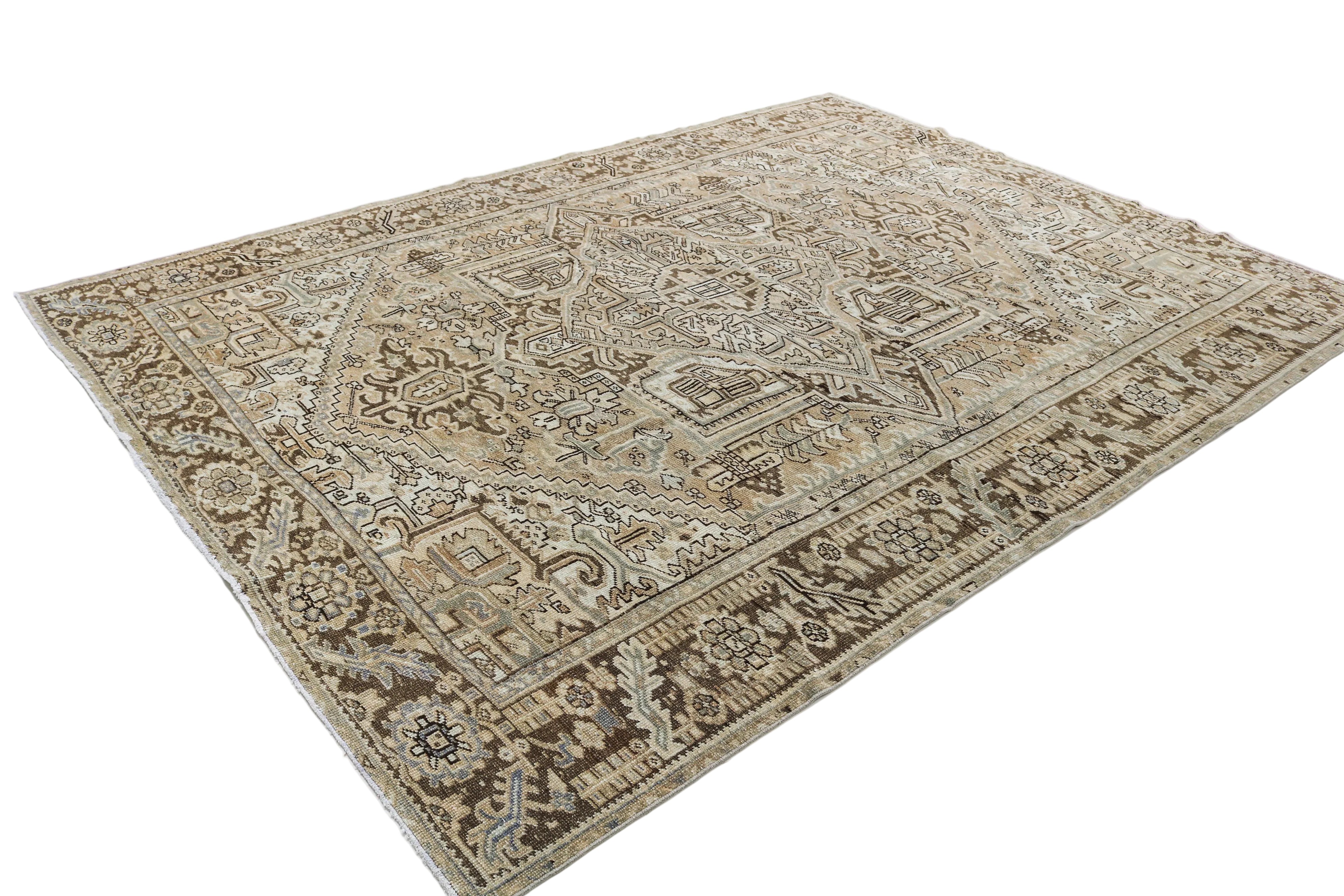 Hand-knotted antique Persian Heriz rug with bold tribal motifs and naturally faded colours
