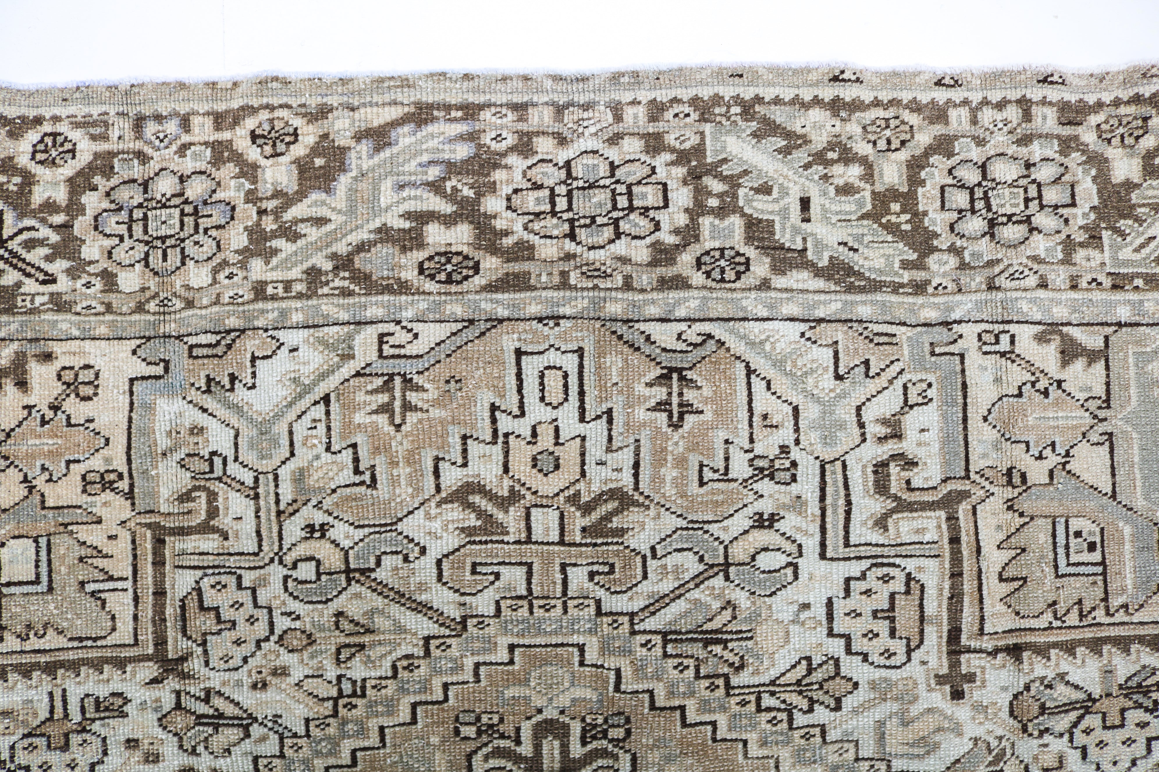 Handwoven Persian Heriz rug detail with refined tribal drawing and authentic aged character