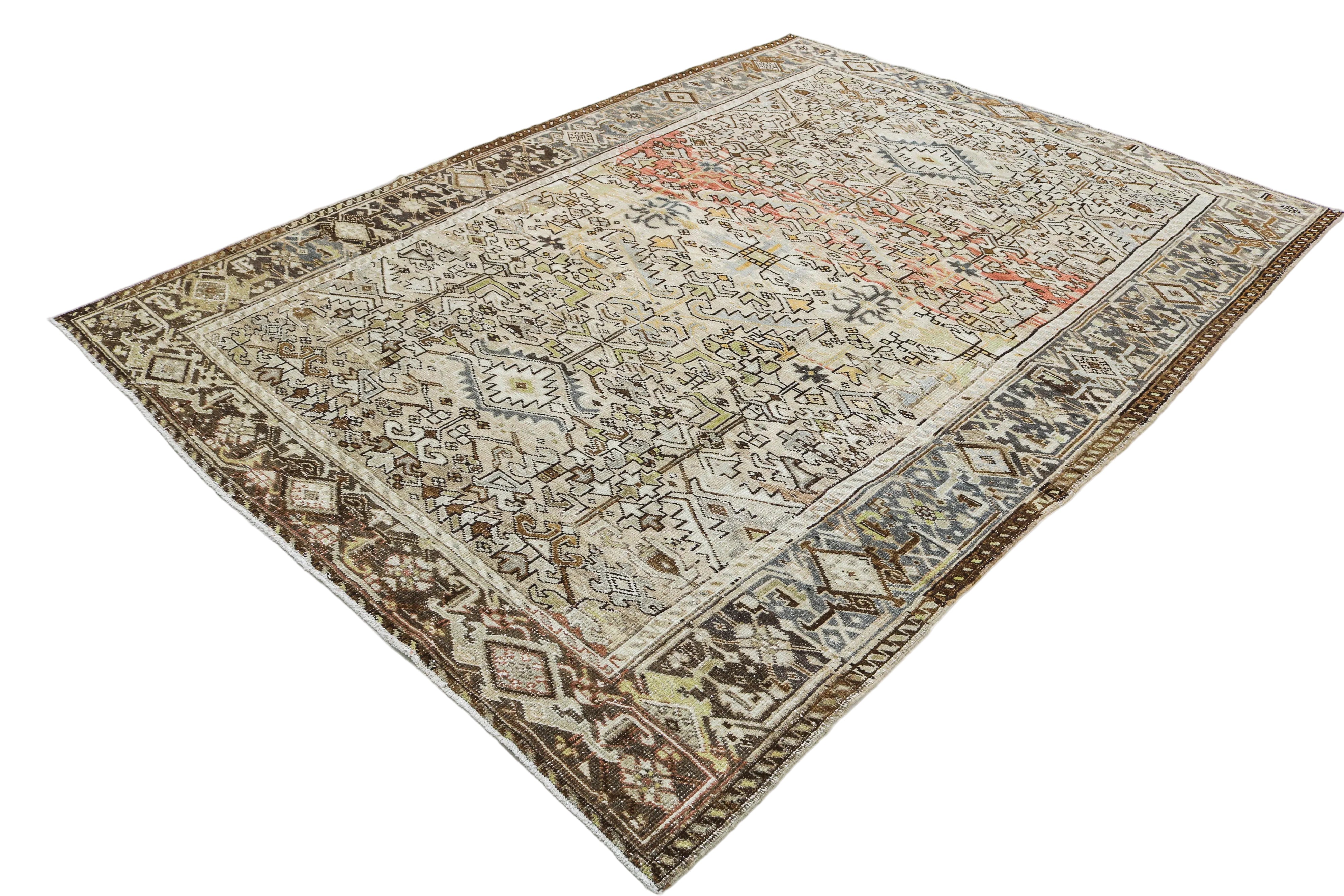 Hand-knotted antique Persian Heriz rug with tribal geometric pattern and naturally faded colours