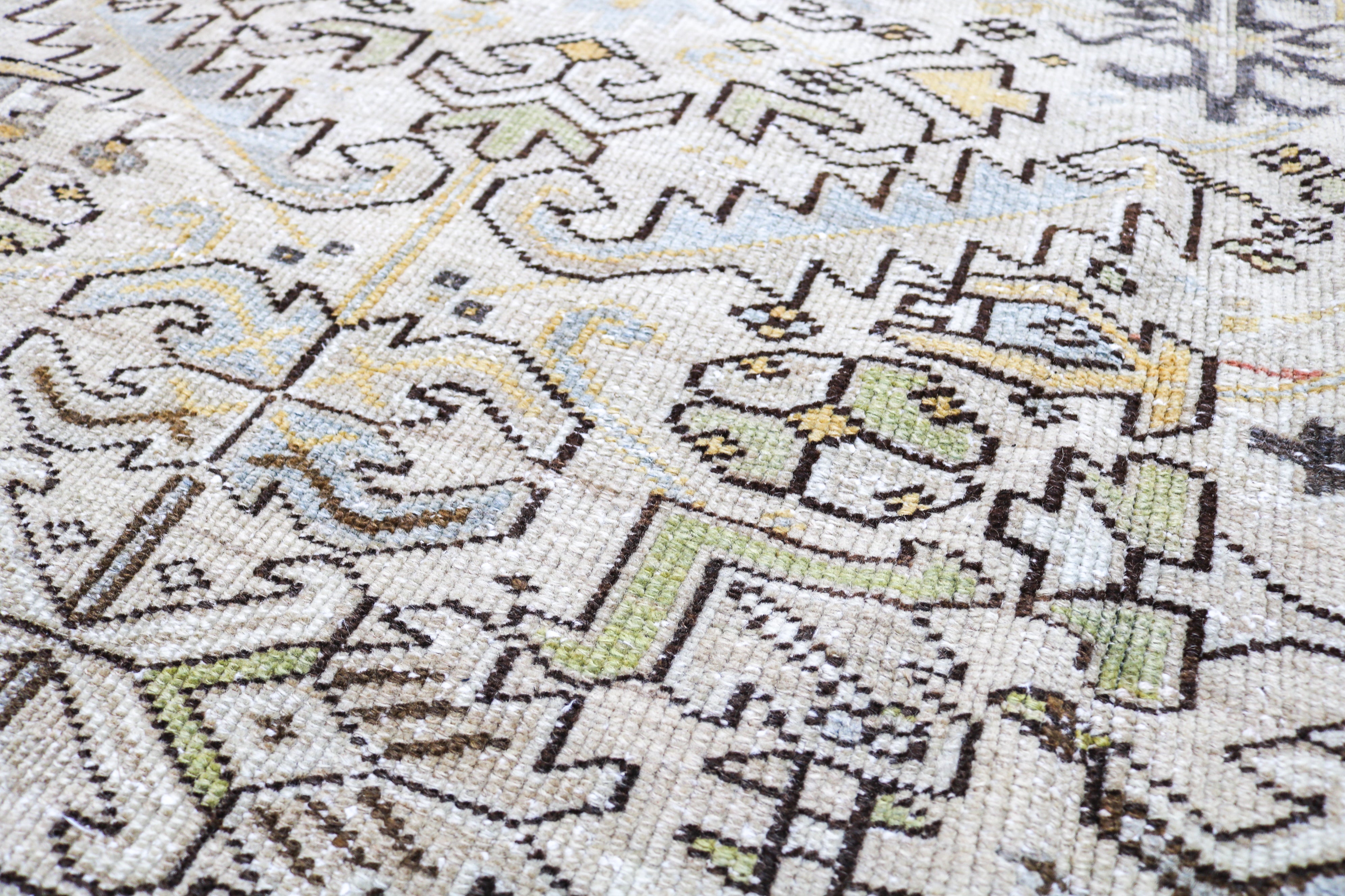 Handwoven Persian Heriz rug detail with refined geometric drawing and naturally aged character