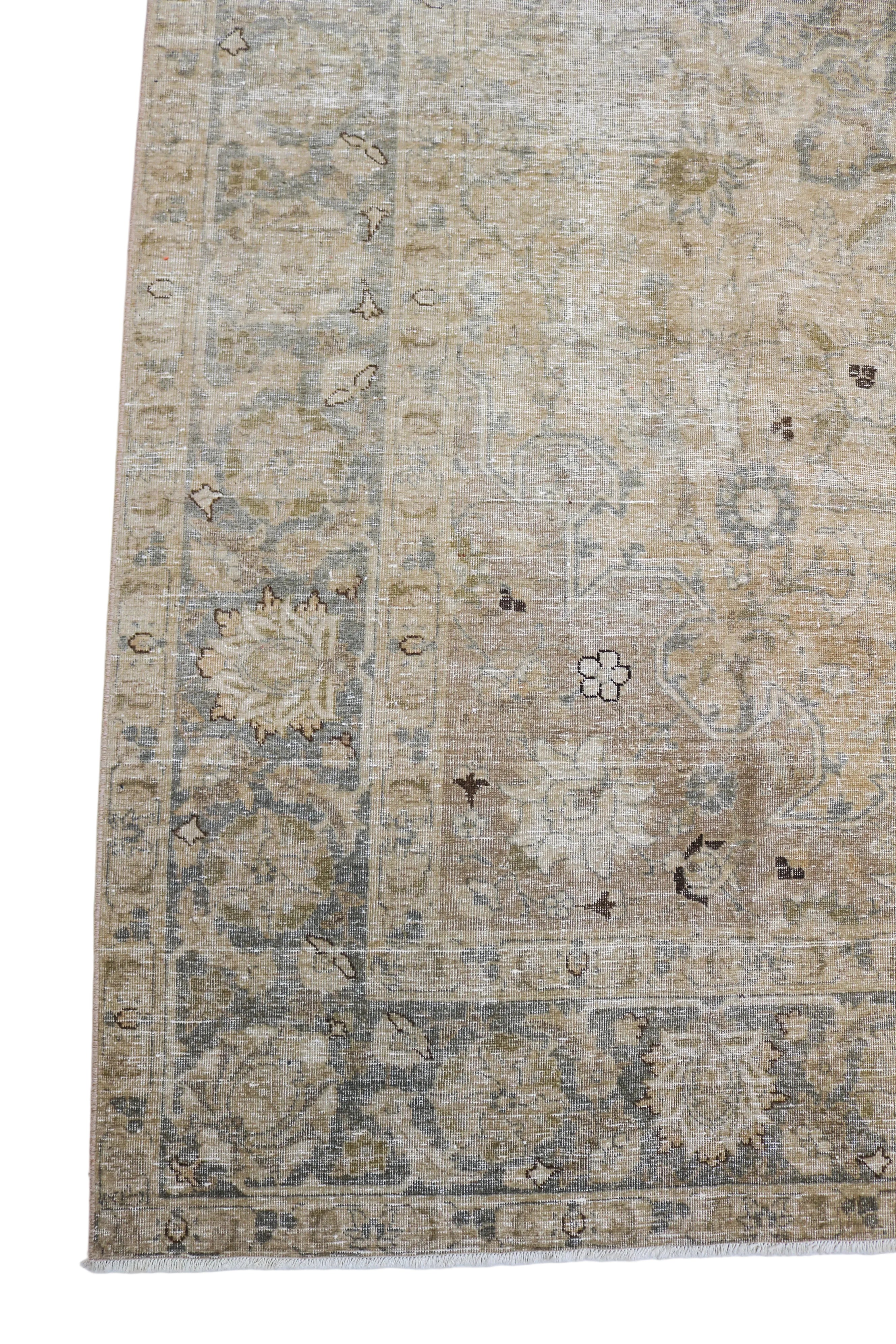 Antique Persian Tabriz carpet corner detail with floral border and softly aged neutral tones circa 1930
