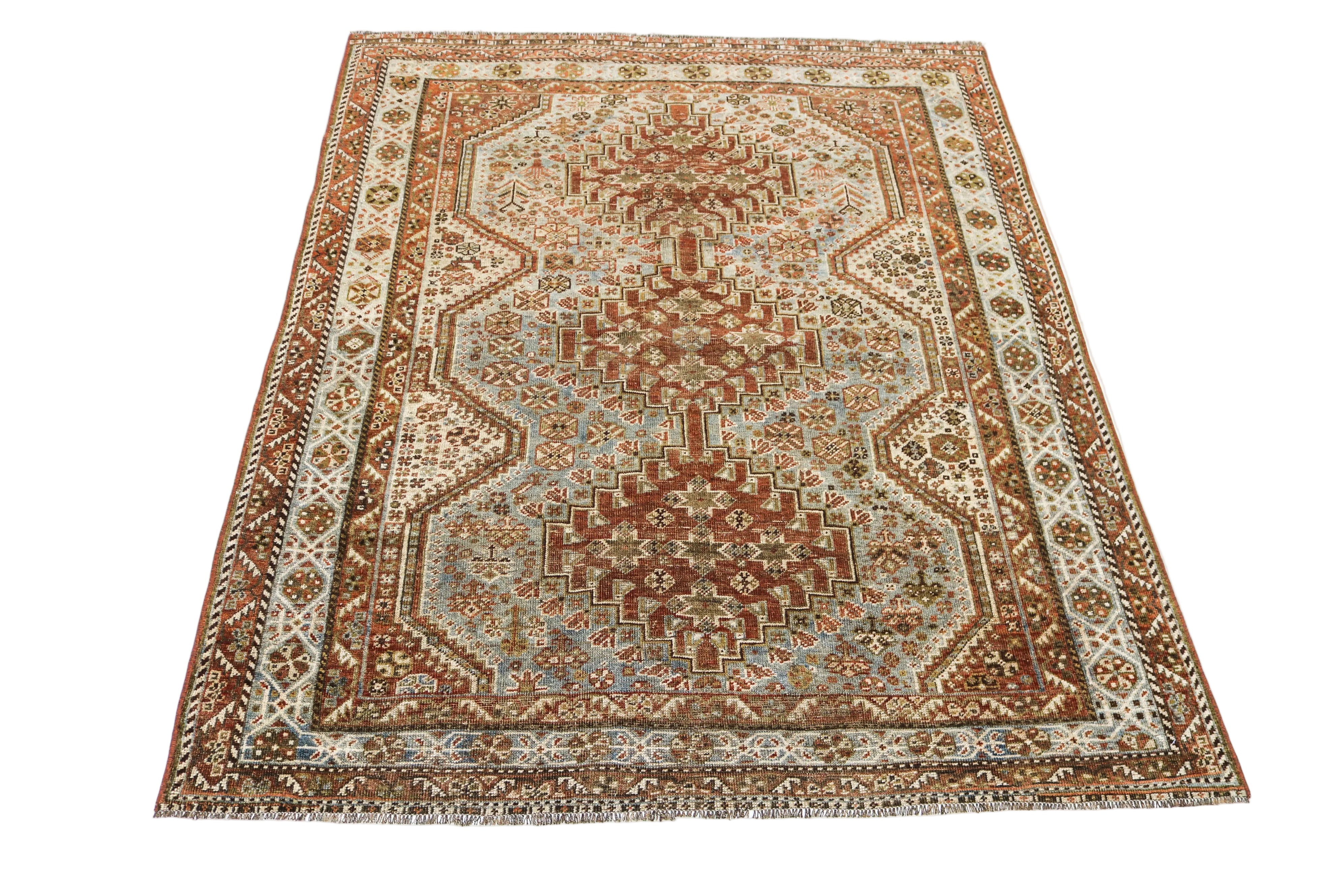 Large antique Persian Qashqai rug with stepped geometric medallion in terracotta red and ivory tones