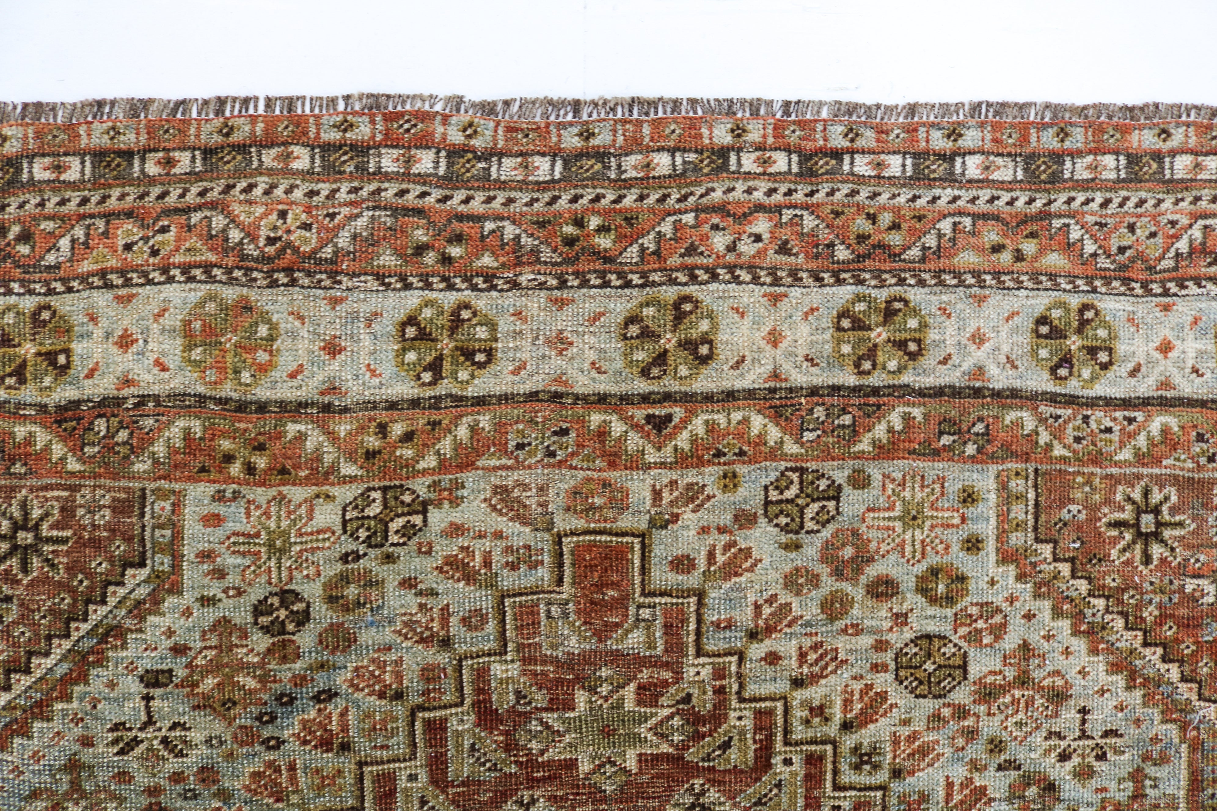Hand-knotted antique Persian Qashqai rug with tribal geometric motifs and naturally aged colours