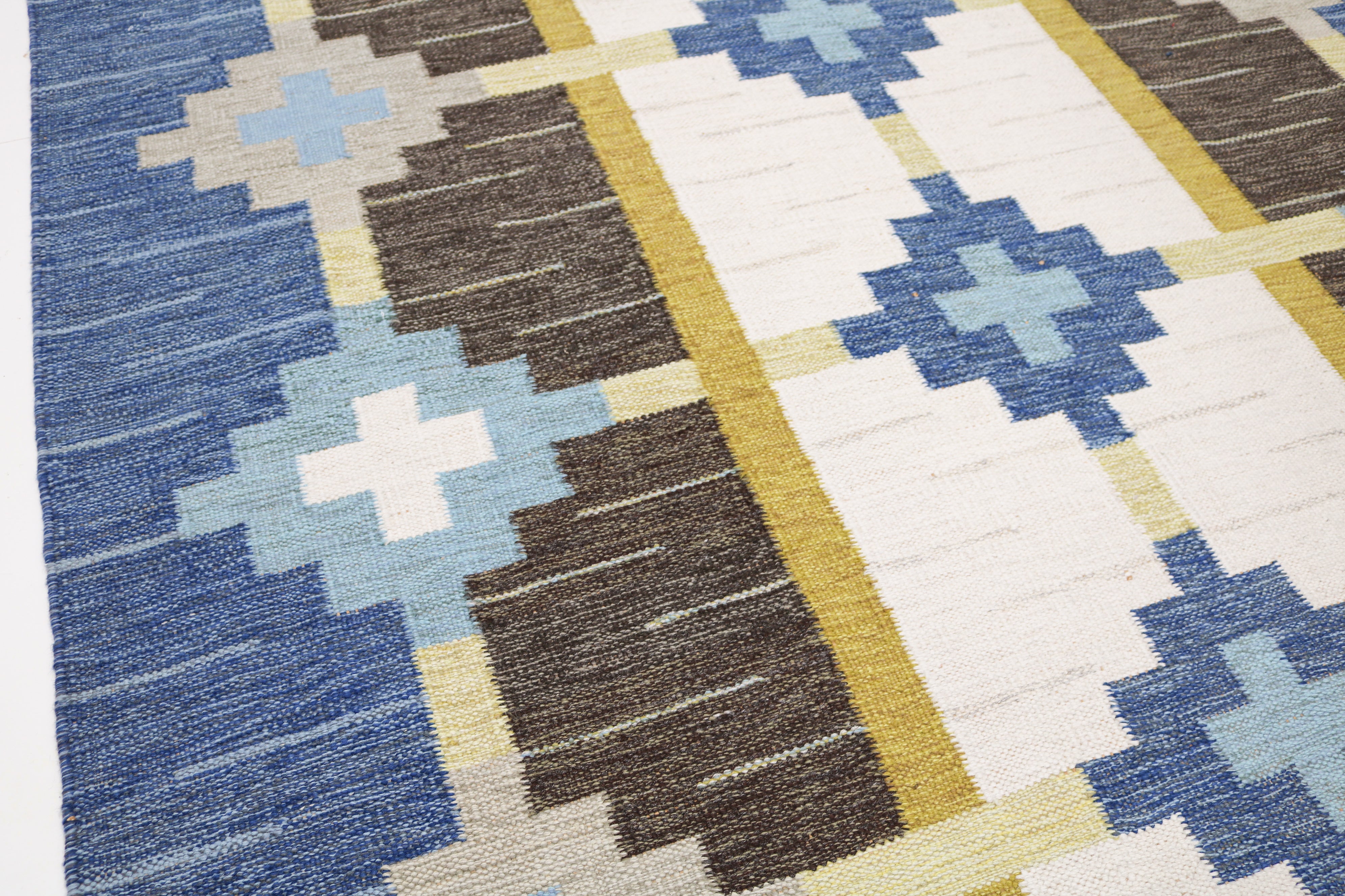 Detail of handwoven vintage Swedish kilim with blue and brown geometric motifs