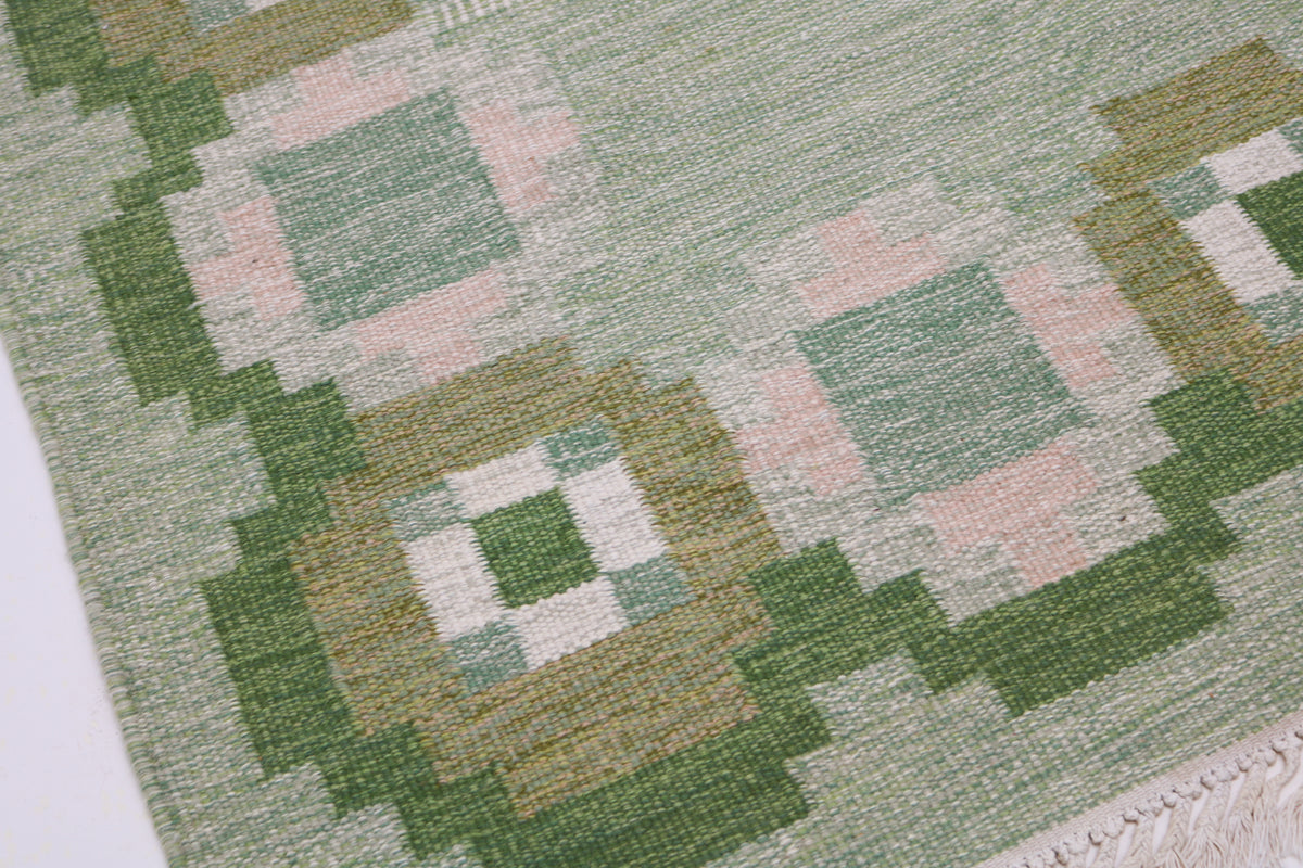 Close-up of vintage Swedish Kilim rug with repeating geometric motifs and muted colours