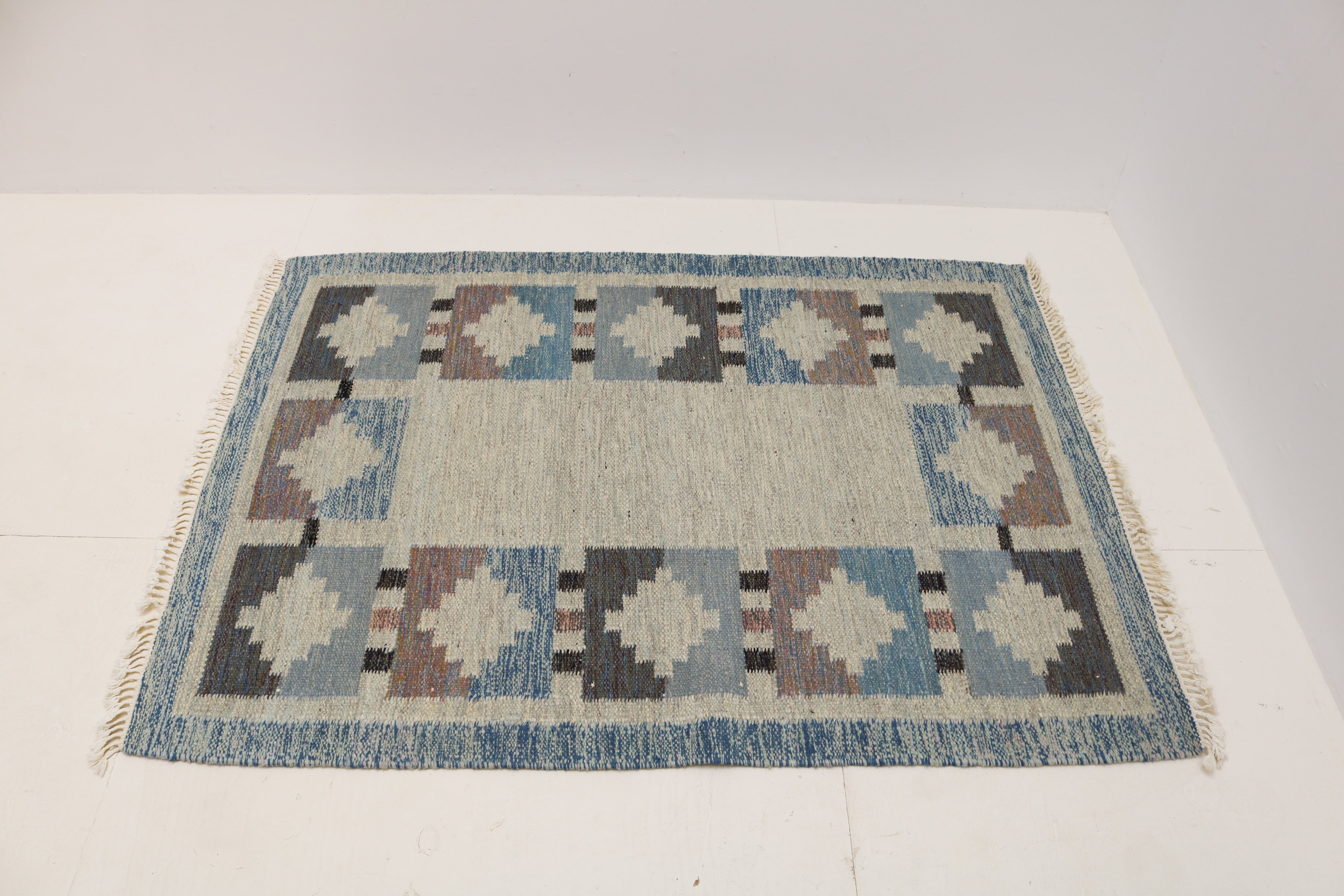 Handwoven Swedish flatweave rug with mid-century geometric border