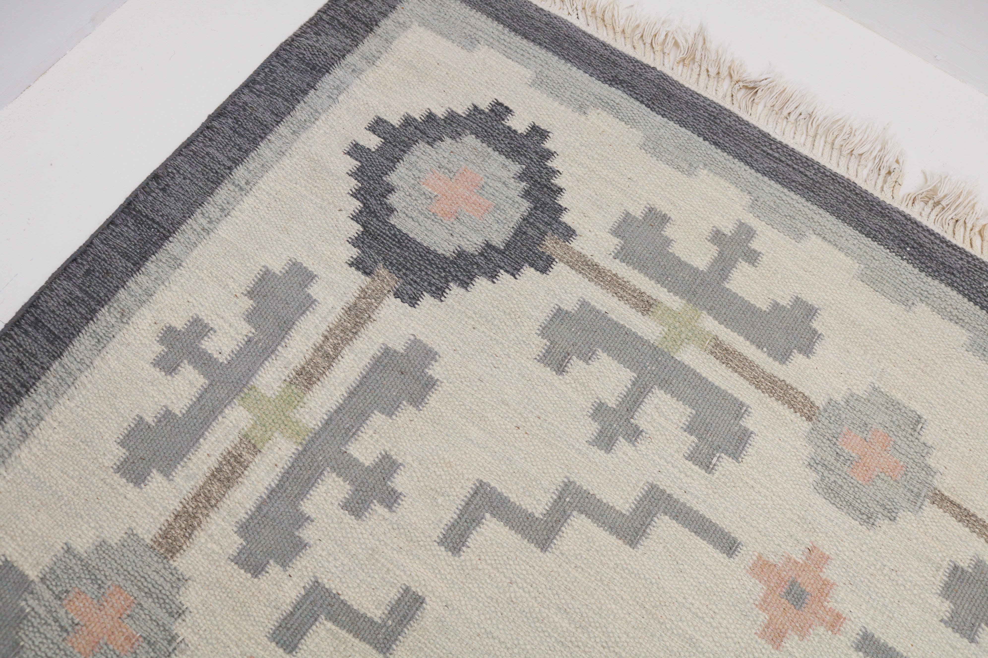 Detail of handwoven vintage Swedish rug with Scandinavian geometric design
