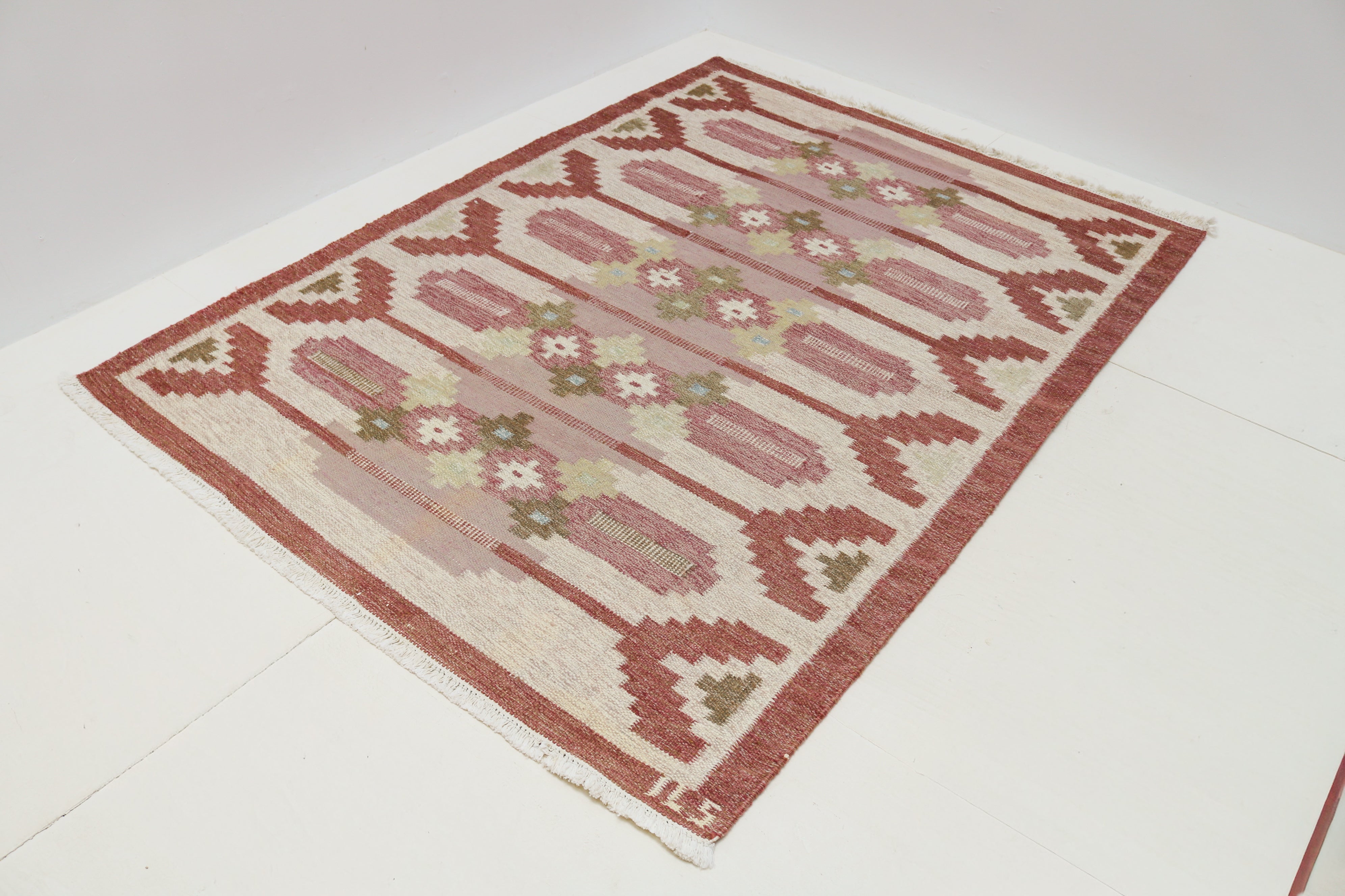 Handwoven wool detail of vintage Swedish flatweave rug with muted Scandinavian colours