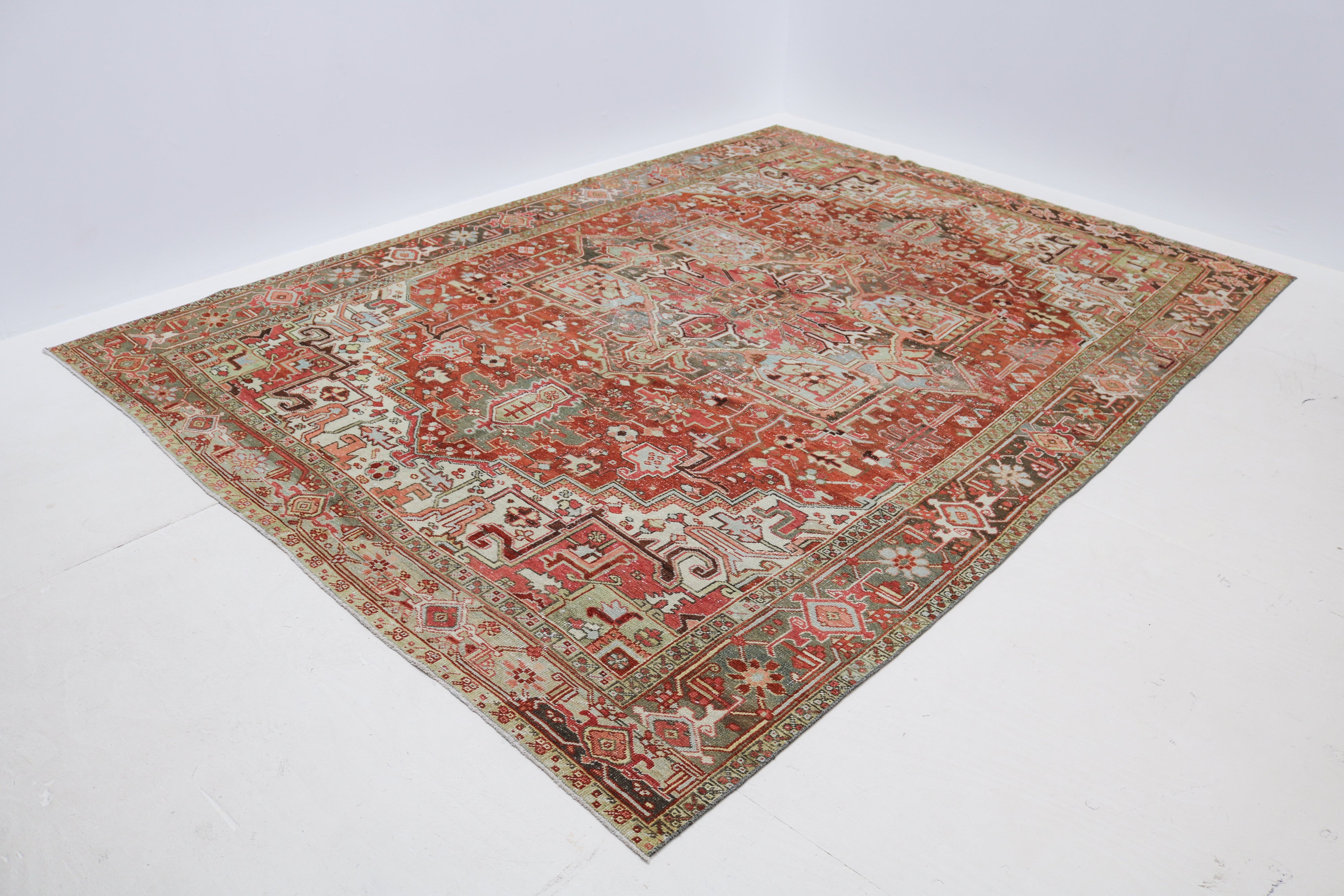 Hand-knotted wool detail of antique Persian Heriz rug circa 1920 showing natural age-related wear