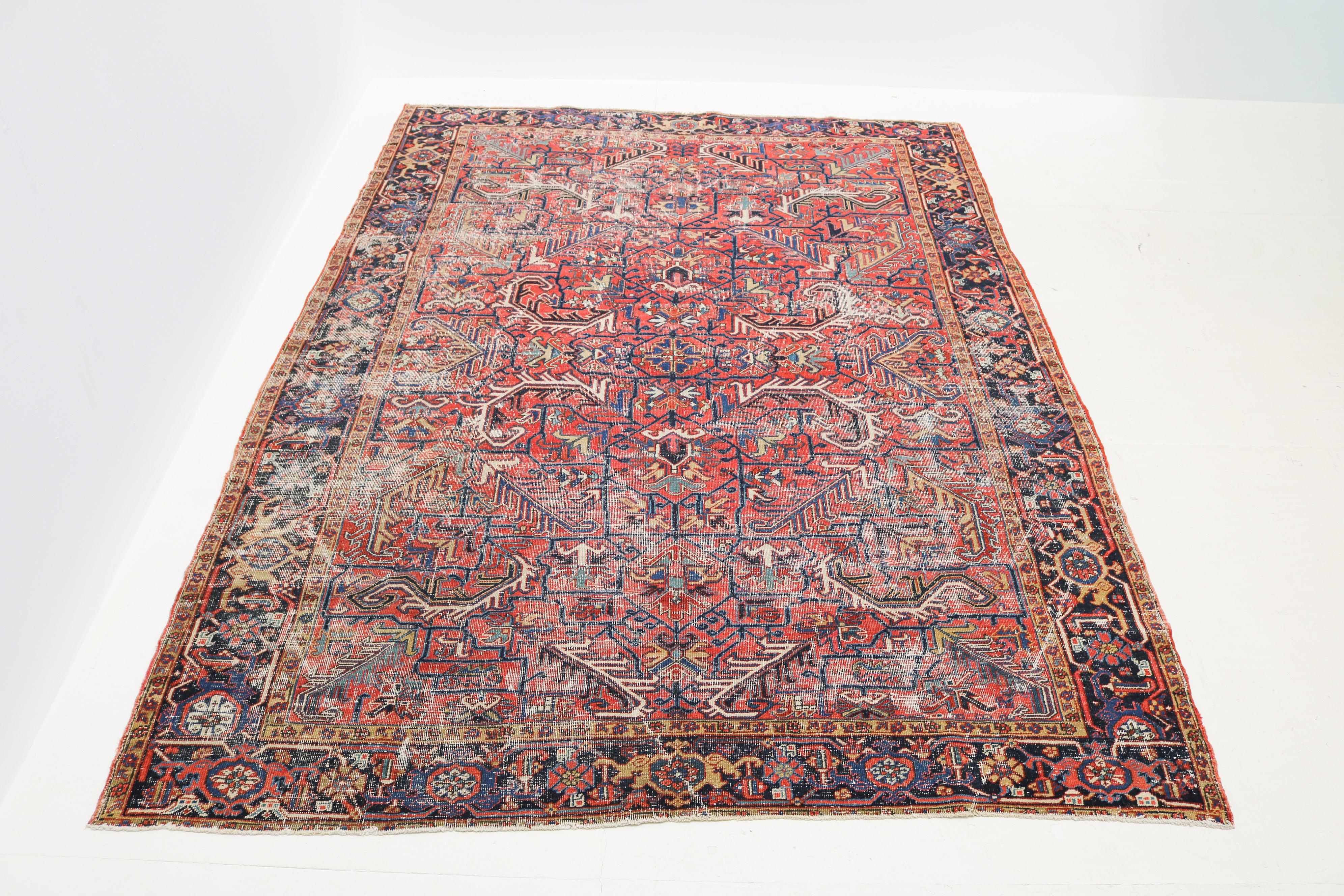 Antique Heriz rug detail with terracotta, ivory, sage green and pale blue geometric motifs