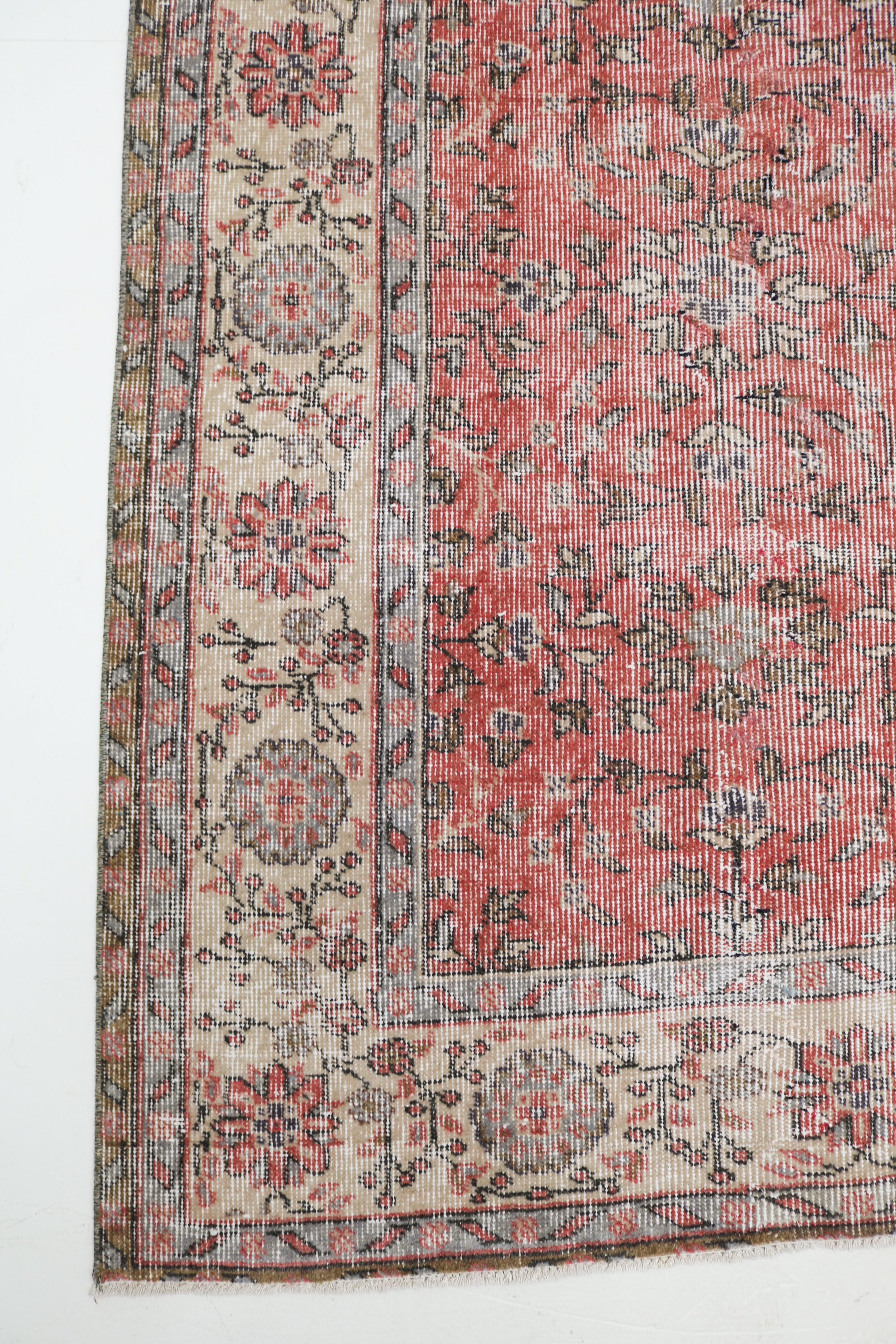 Vintage Turkish rug 300 × 198 cm with faded coral-red field, ivory floral border and naturally worn patina