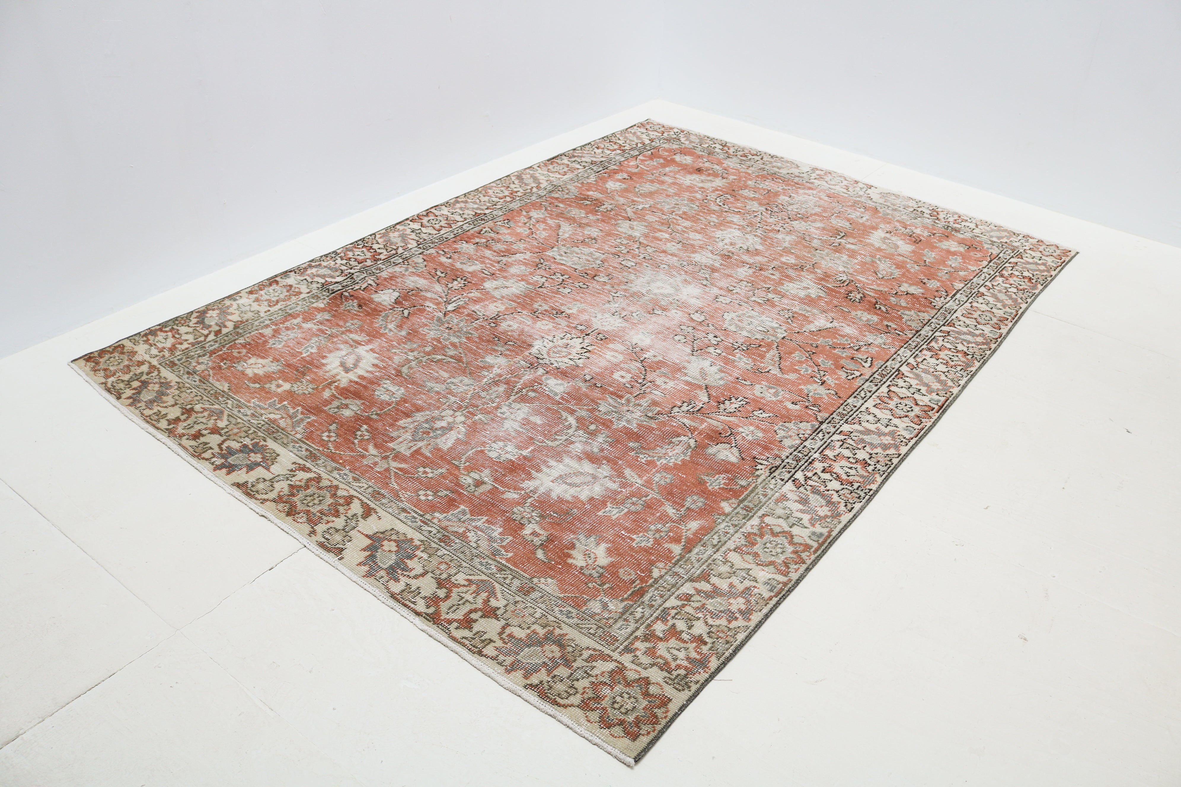 Naturally distressed vintage Turkish rug showing soft floral motifs and beautifully aged low pile