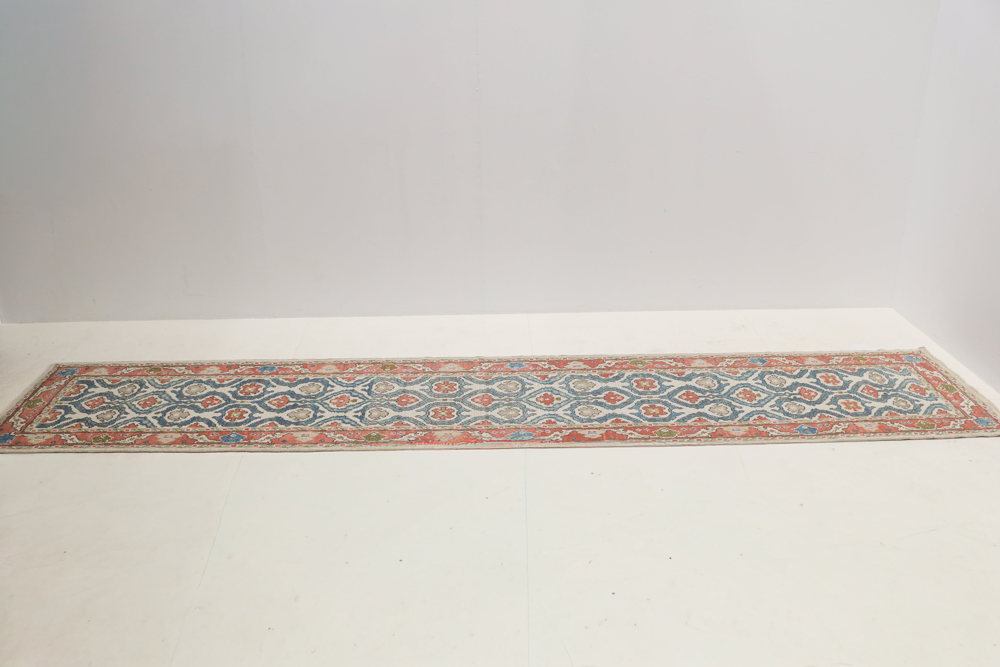 Vintage Turkish Ushak hallway runner with soft muted blue, coral and ivory colours
