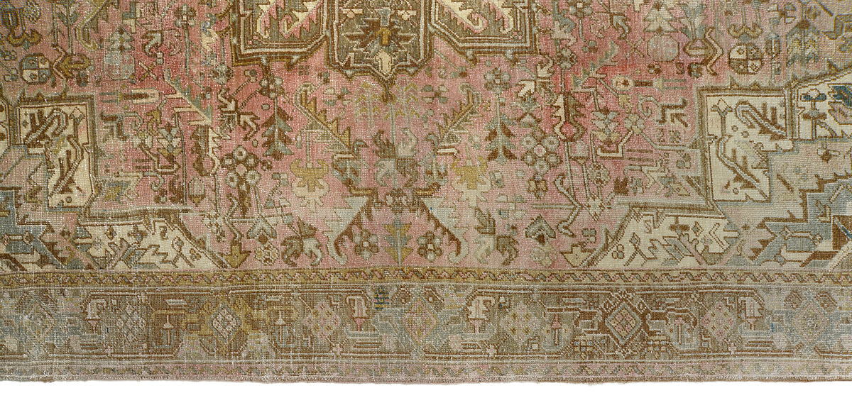 Close-up of vintage Persian Heriz carpet with intricate geometric border patterns