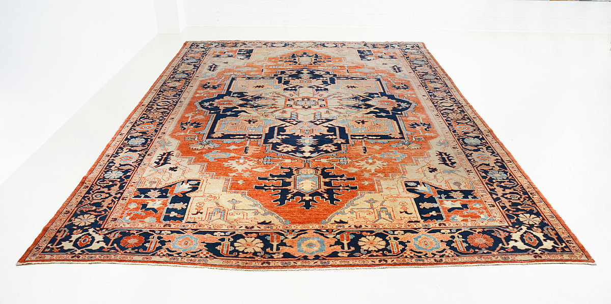 Full view of vintage Heriz Serapi carpet with central medallion and warm terracotta field
