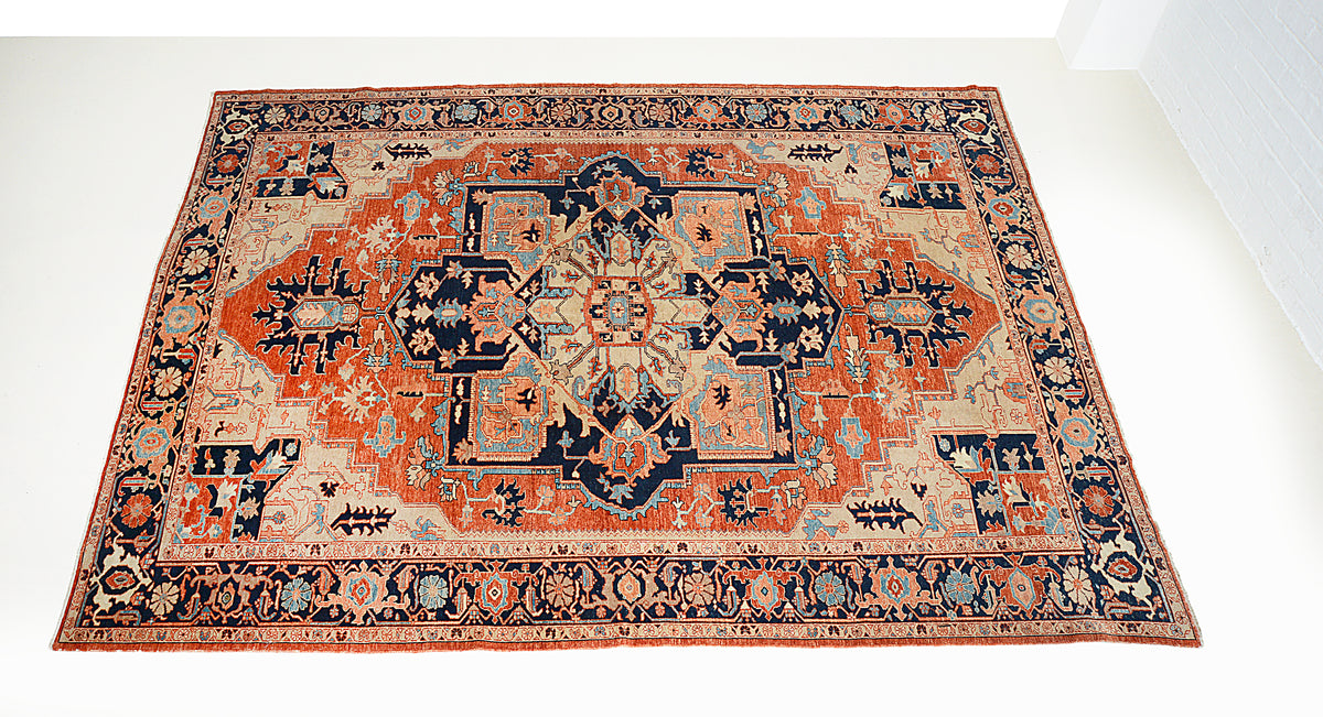 Full view of Heriz Serapi carpet featuring central medallion and geometric floral motifs